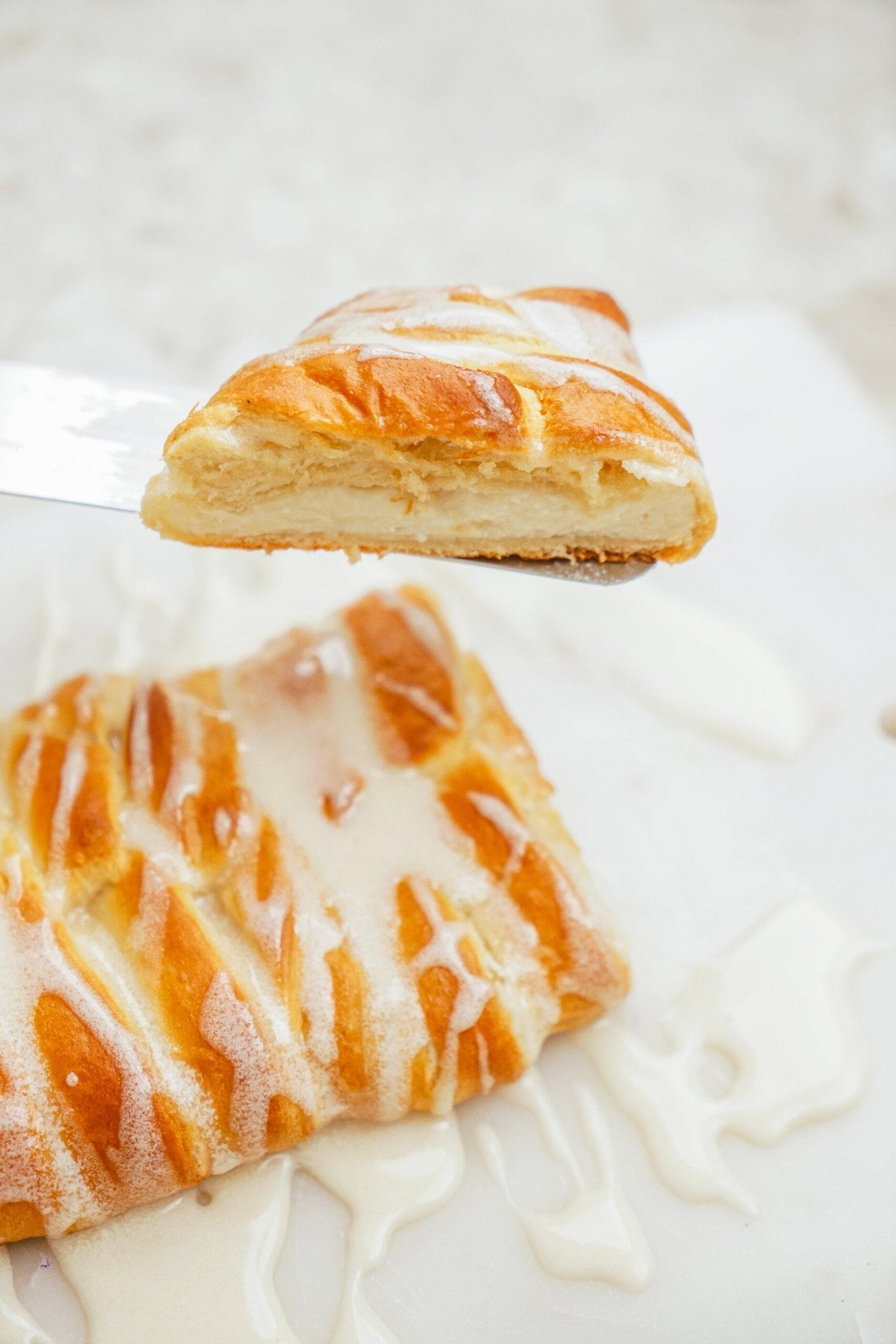 sliced cheese danish on a serving spatula