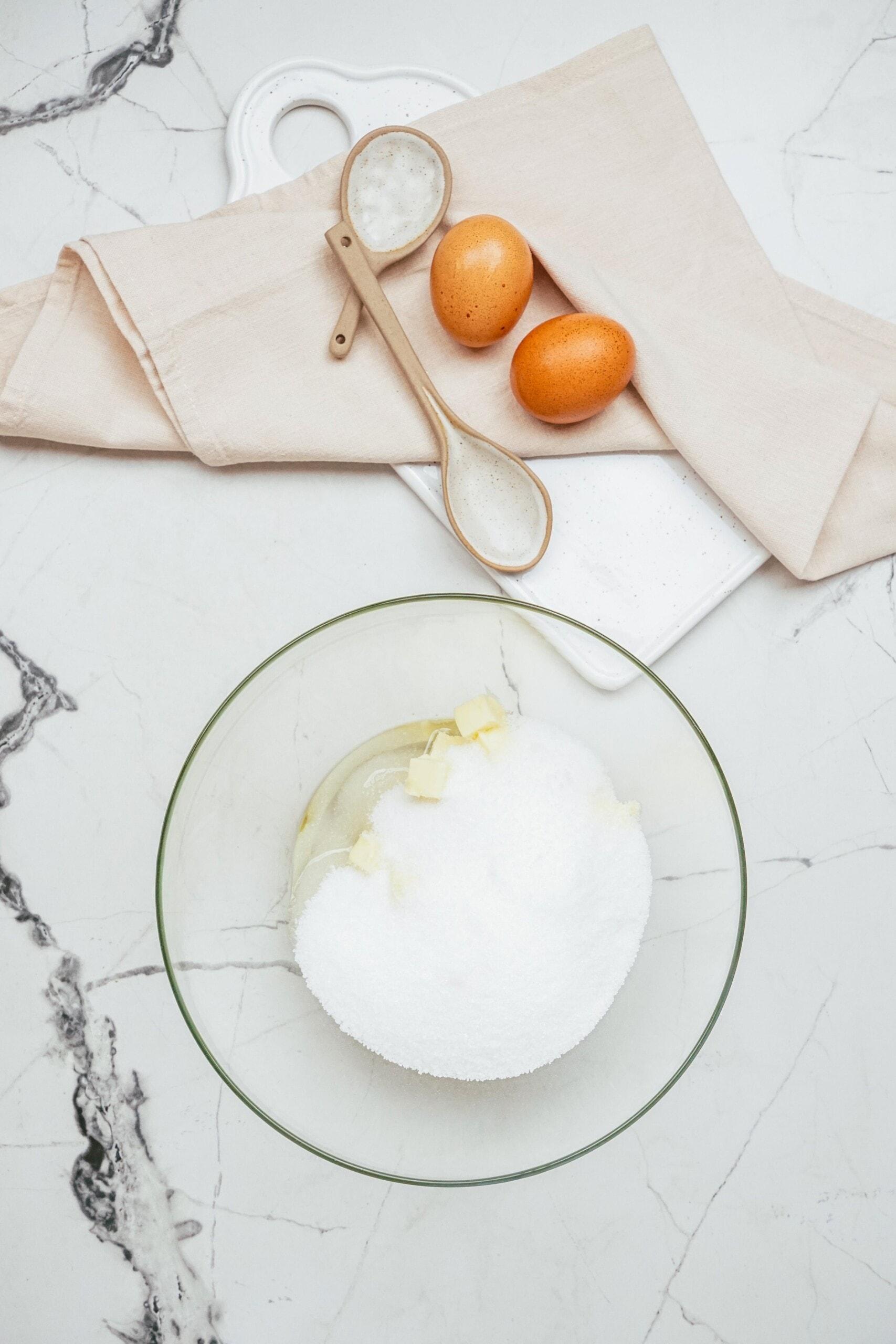 butter and sugar in a glass mixing bowl