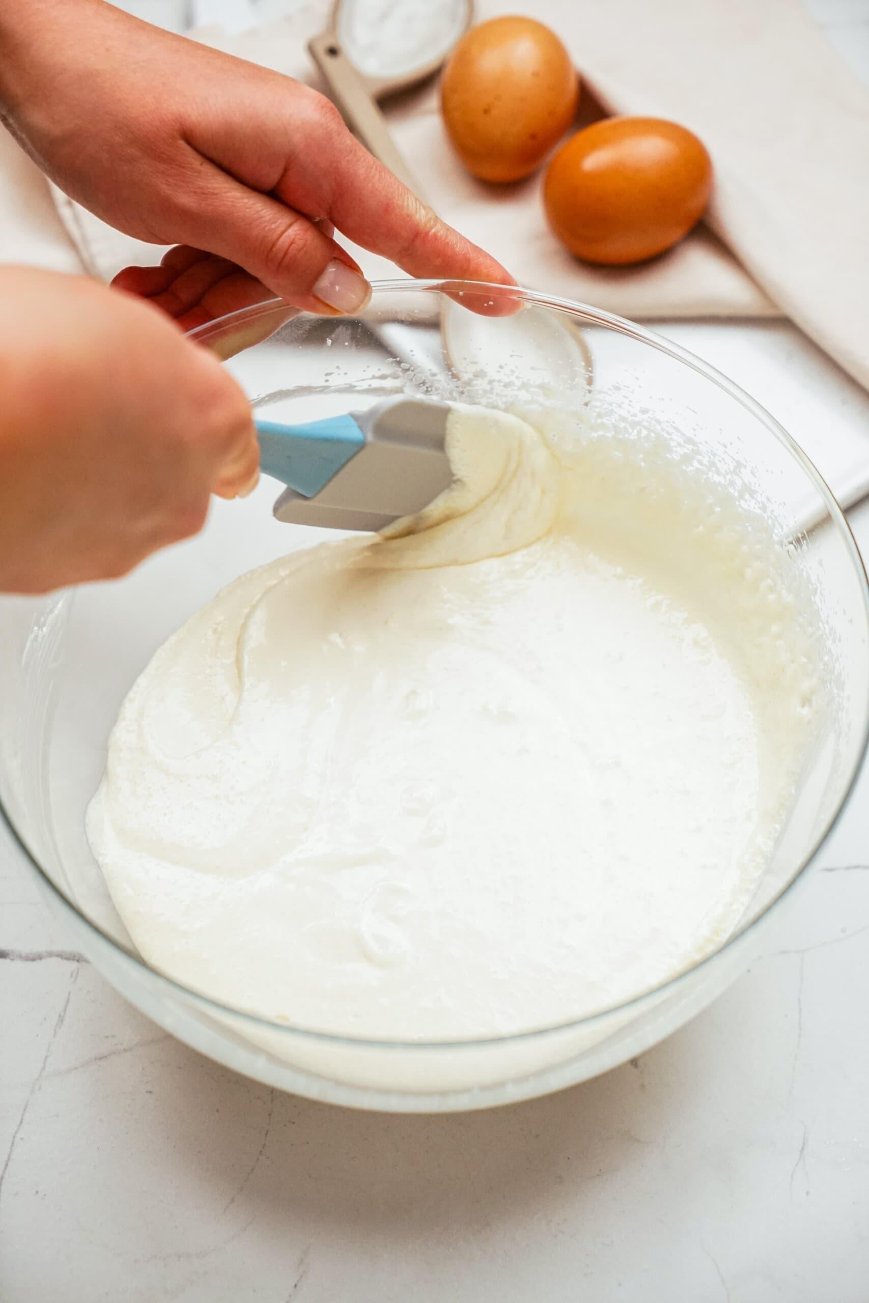 scraping the sides of bowls with rubber spatula