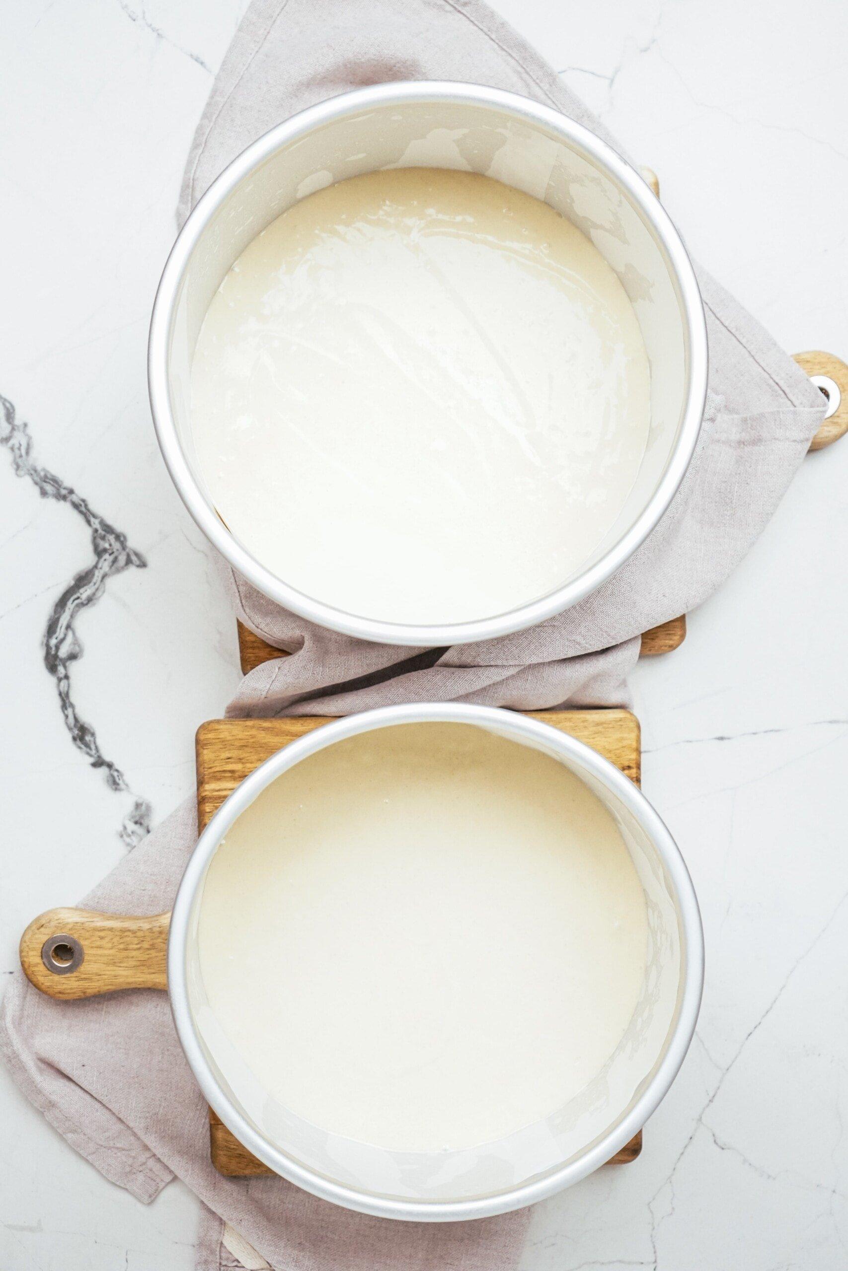 cake batter poured into cake pans