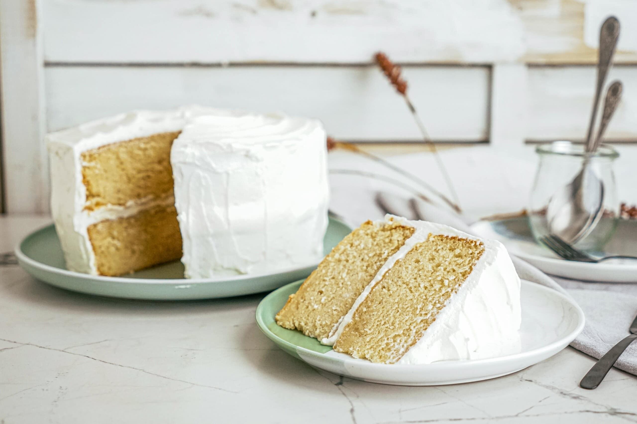 slice of cake on a plate with whole cake in the background