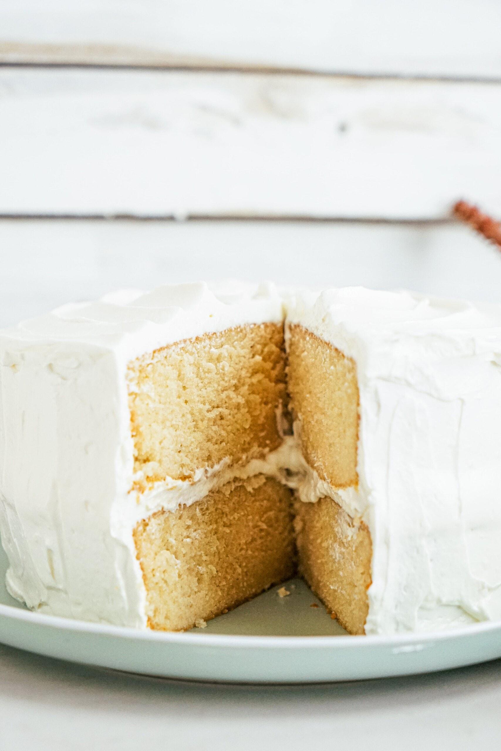 homemade vanilla cake with large slice removed