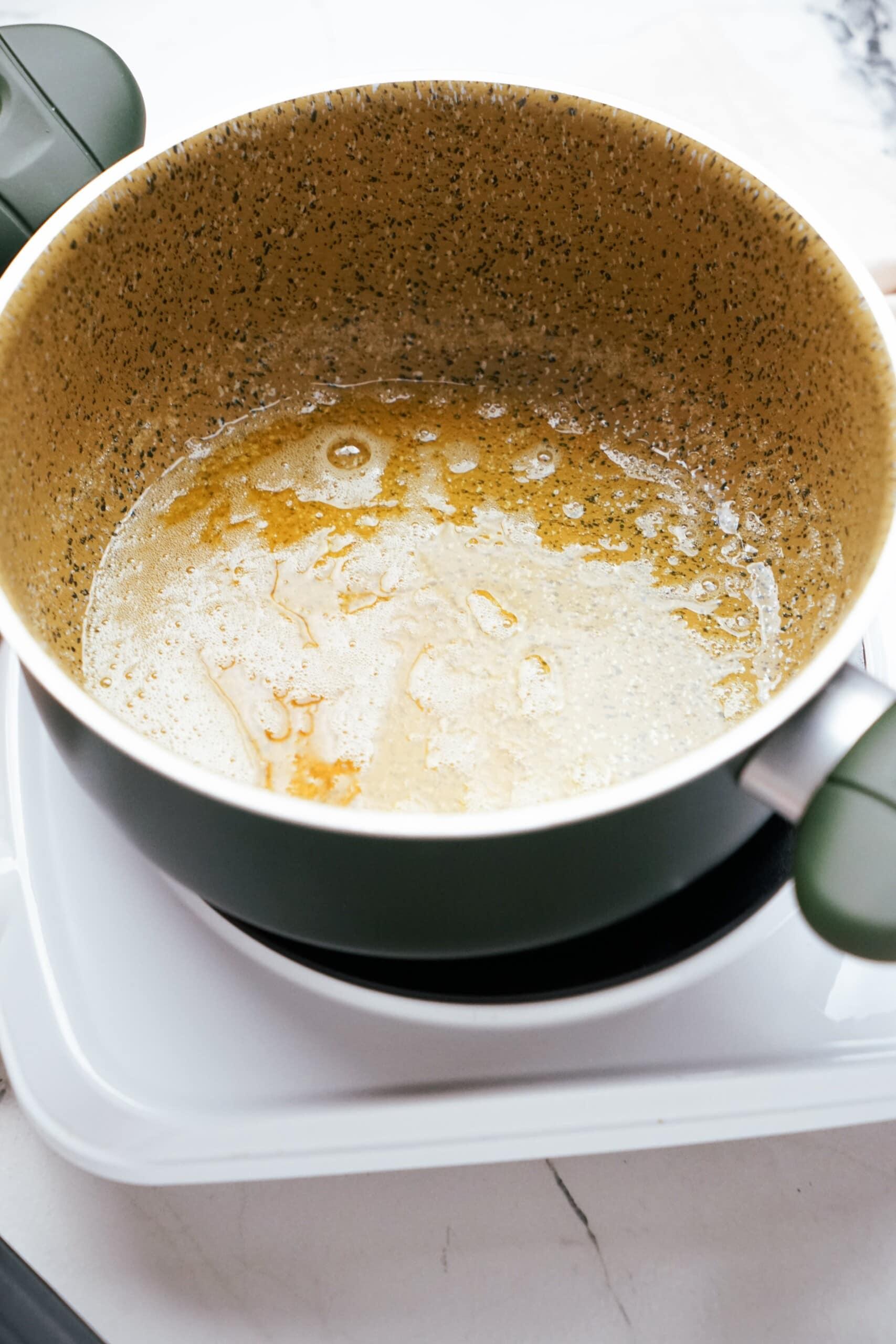 melted butter in a large pot on the stovetop