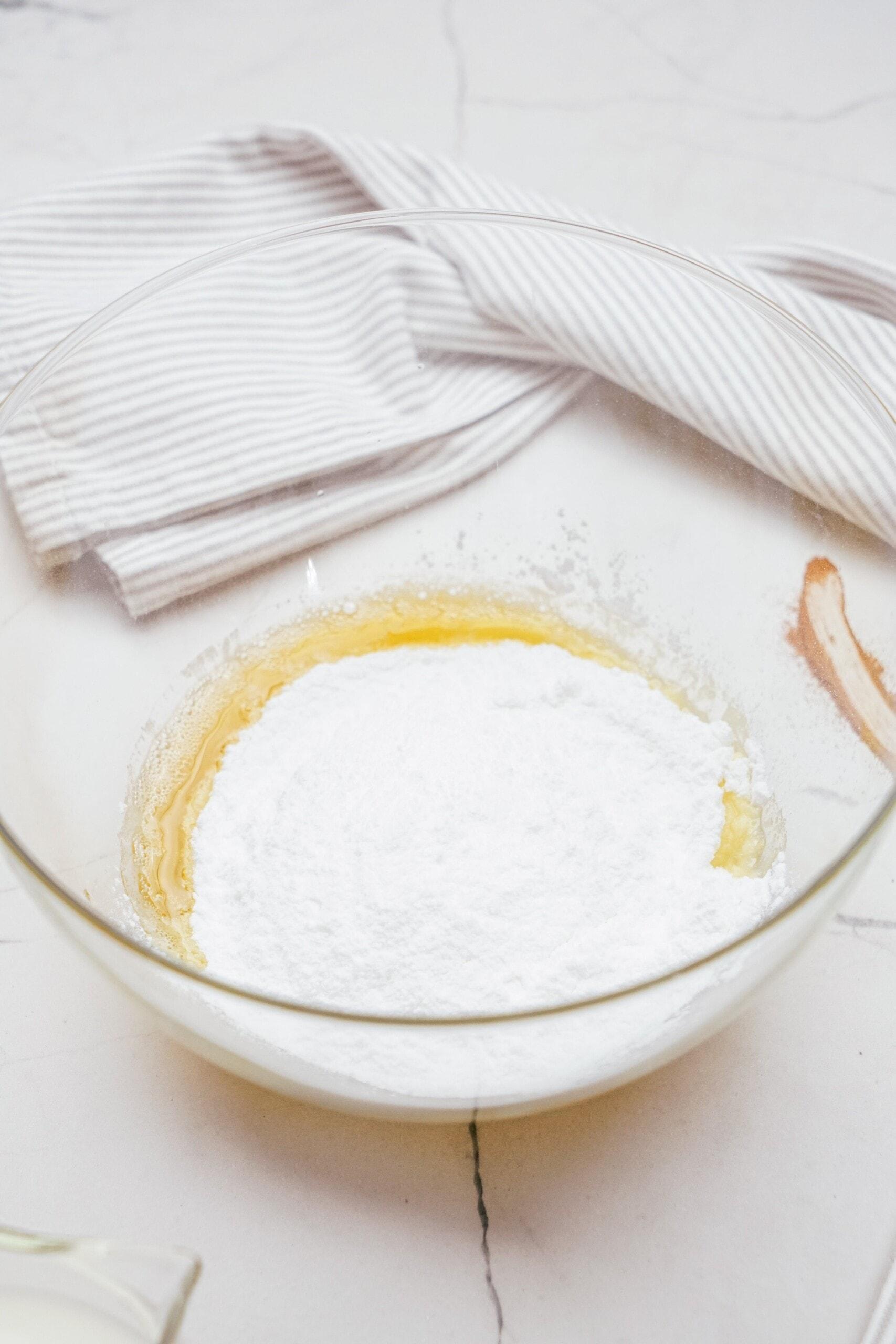 powdered sugar added to the bowl with brown butter