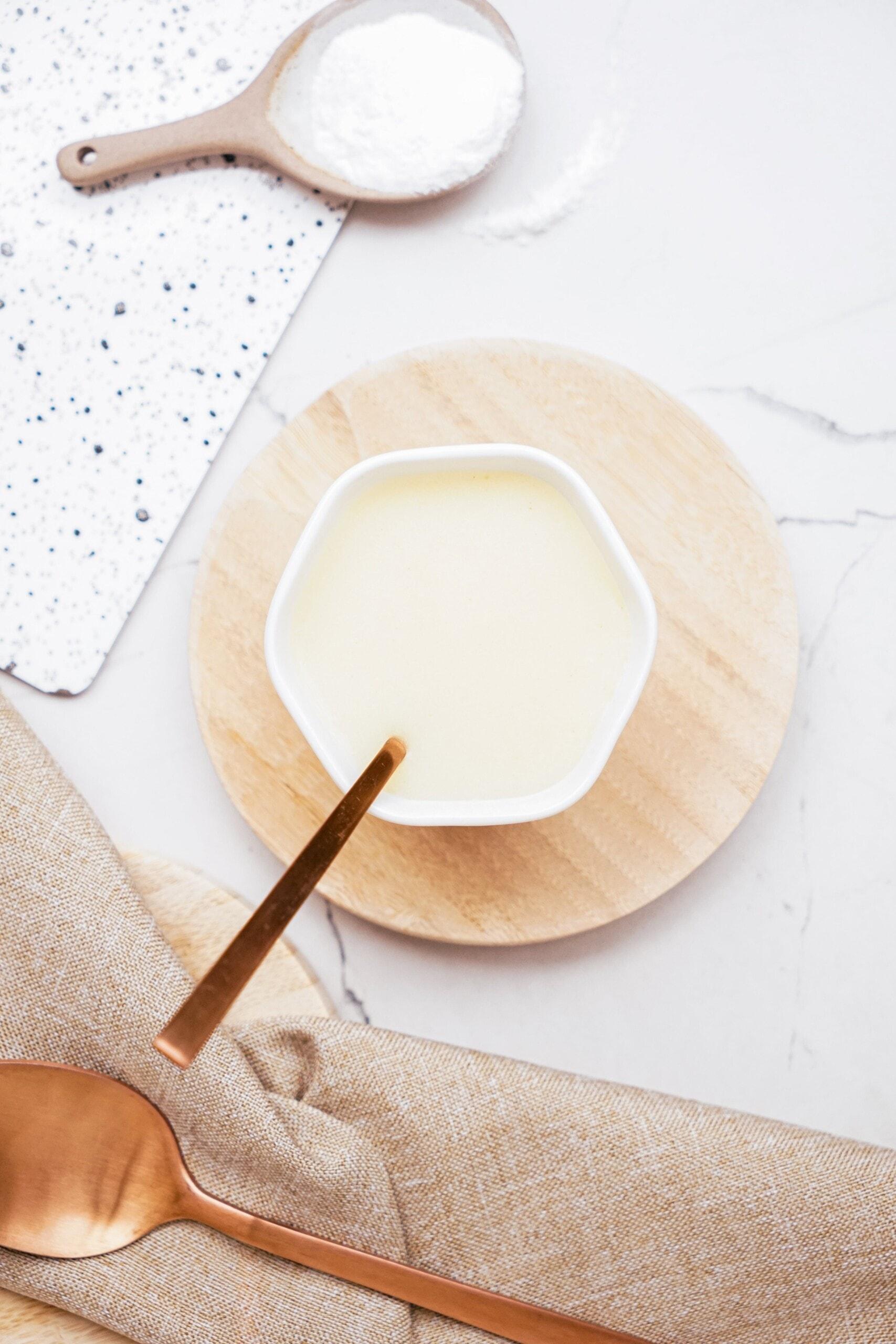 brown butter frosting in bowl with spoon