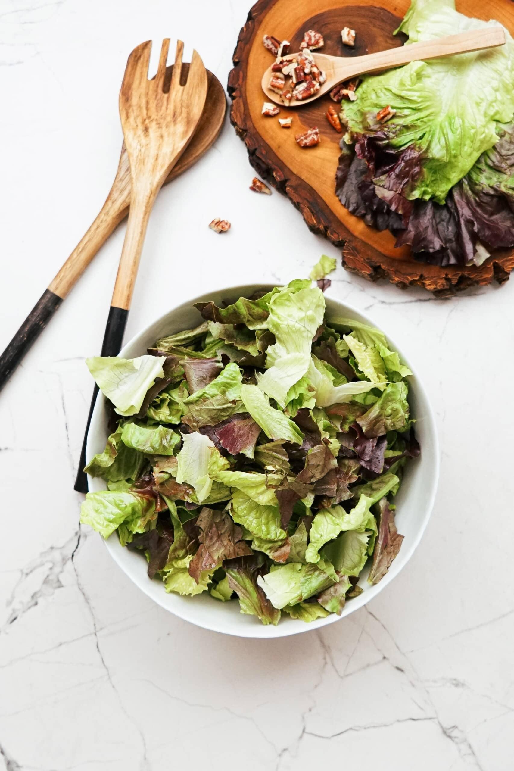 torn red leaf lettuce in a bowl