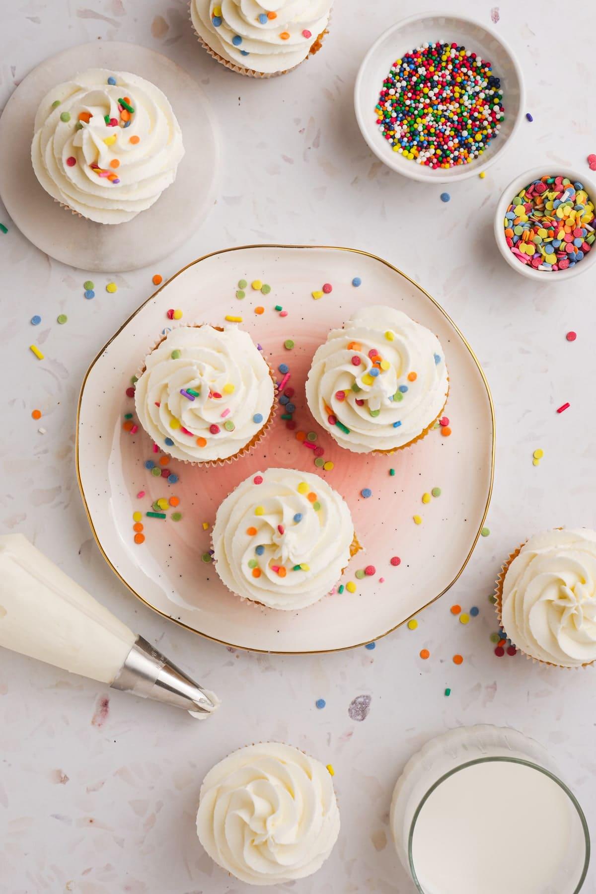 buttercream frosting on 3 cupcakes on tablescape