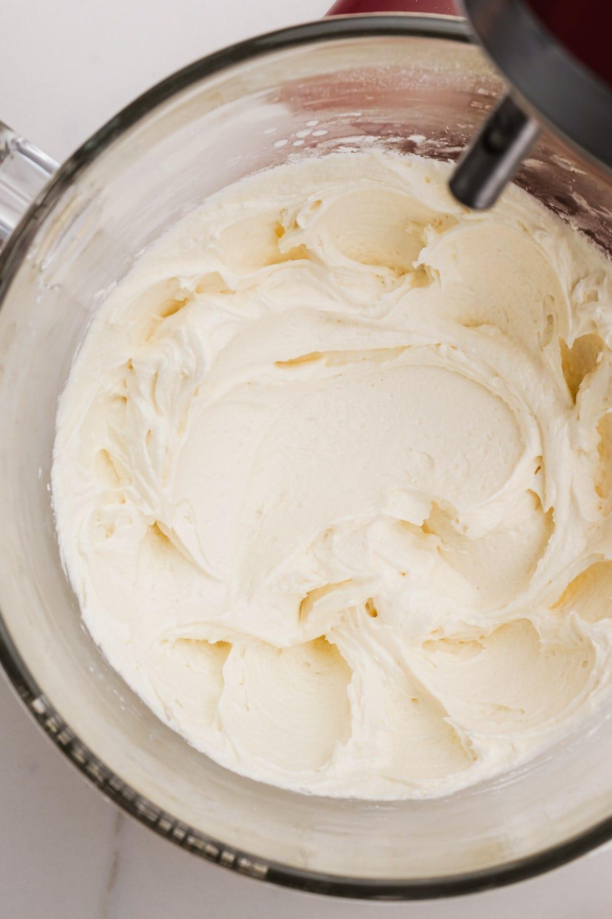 buttercream frosting in glass mixing bowl