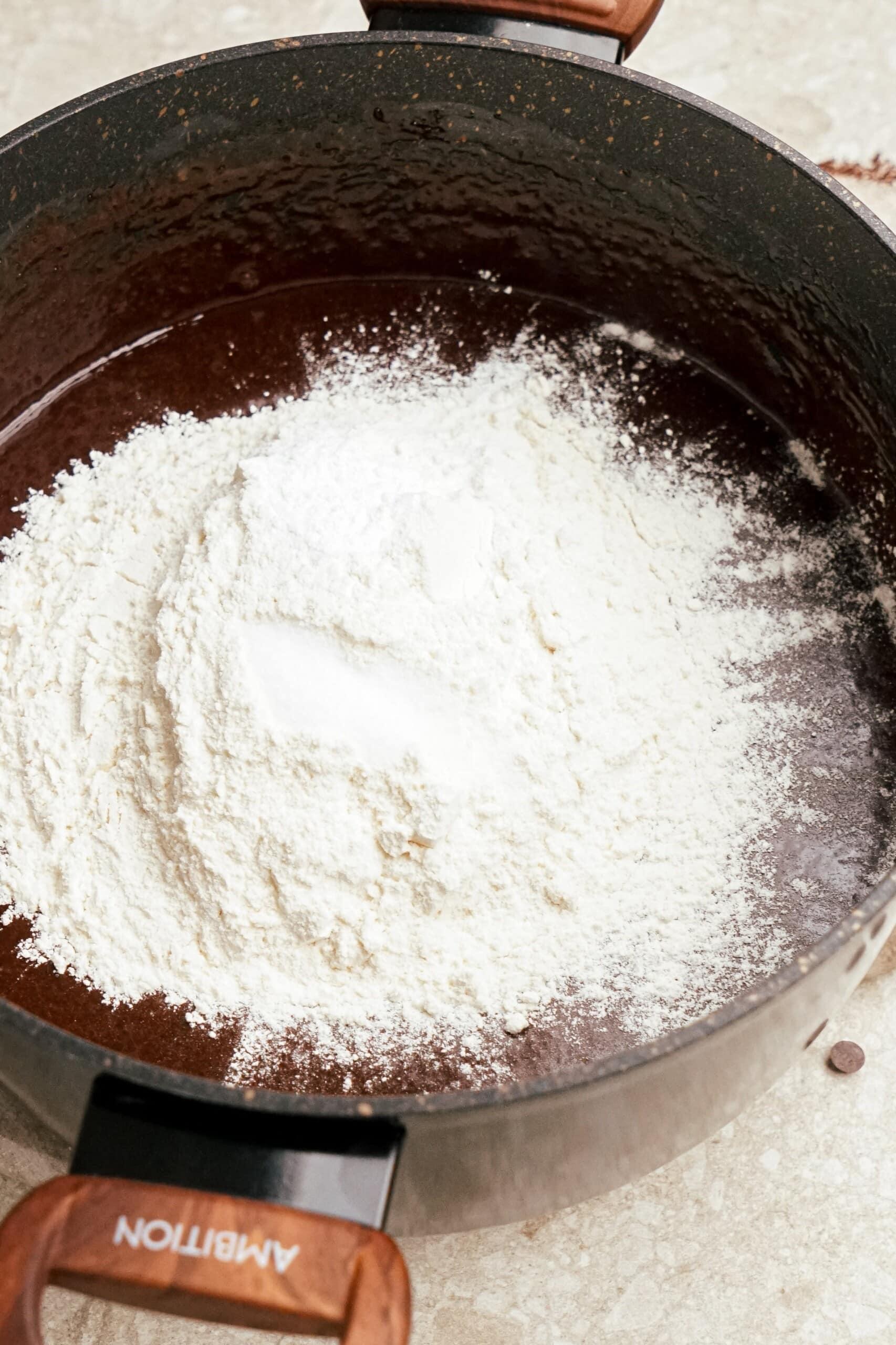 adding dry ingredients to brownie mixture