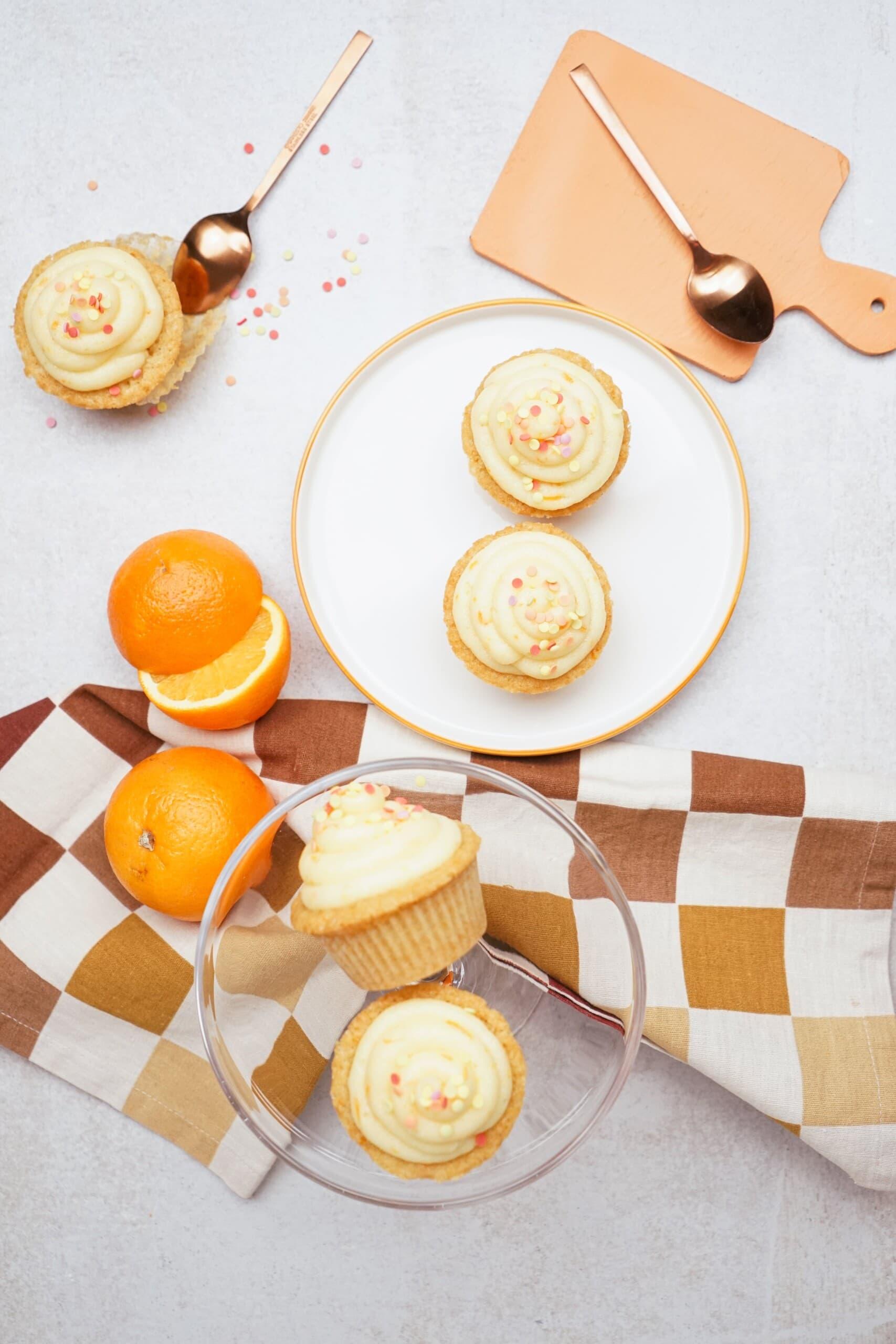 orange cupcakes on a plate and tablescape