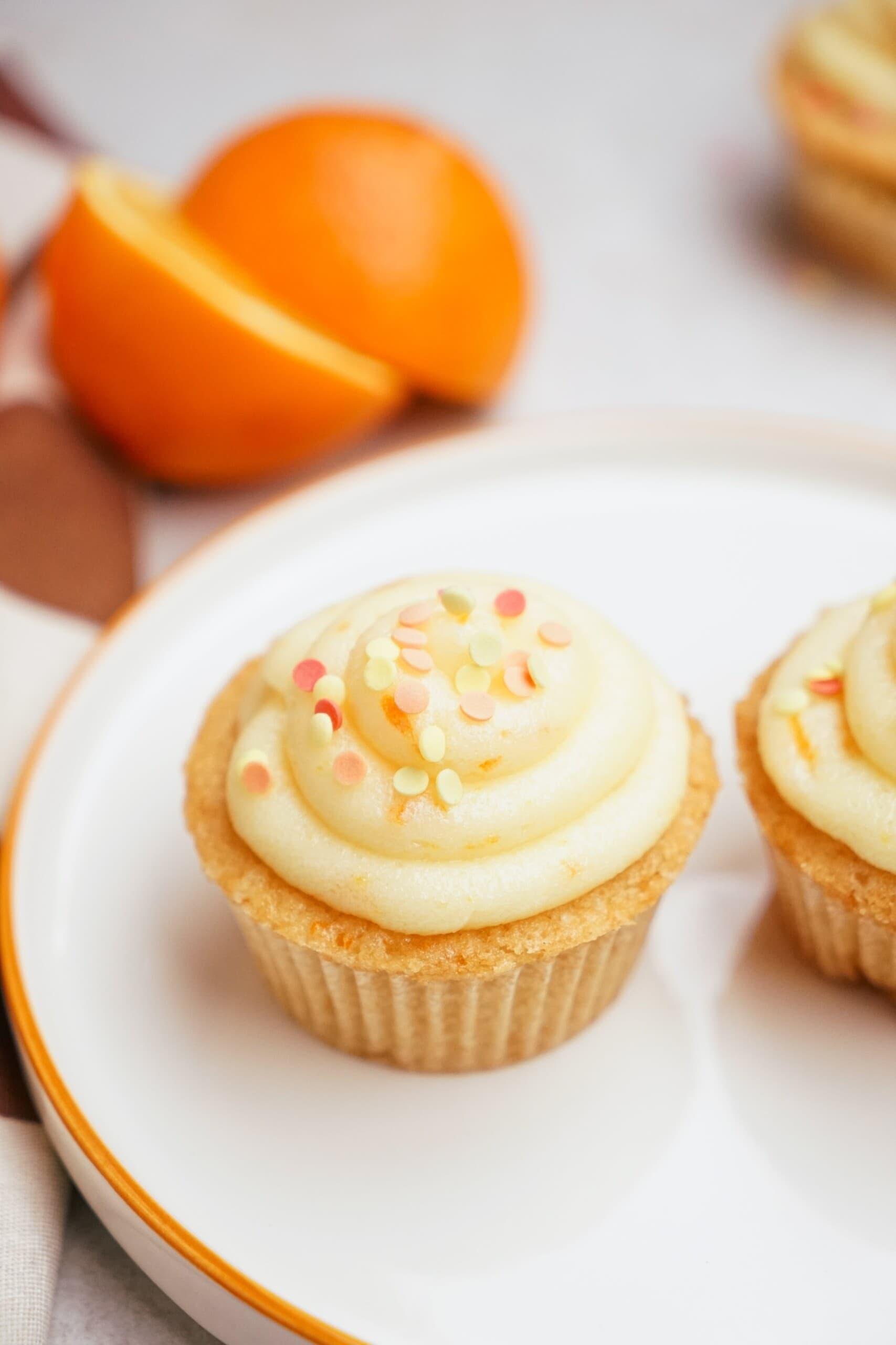 orange cupcakes with orange buttercream frosting