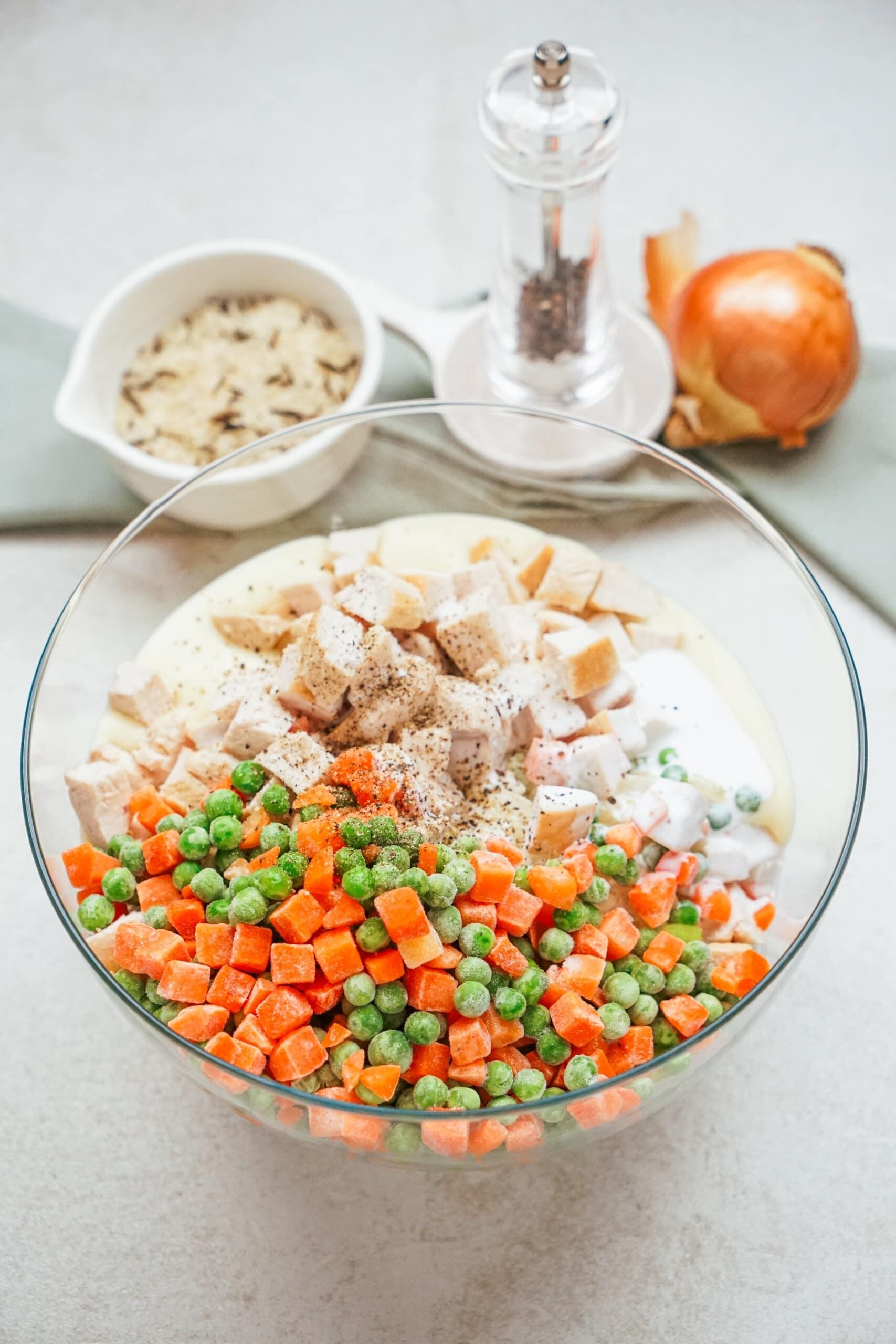 chicken, mixed veggies and rice in a mixing bowl
