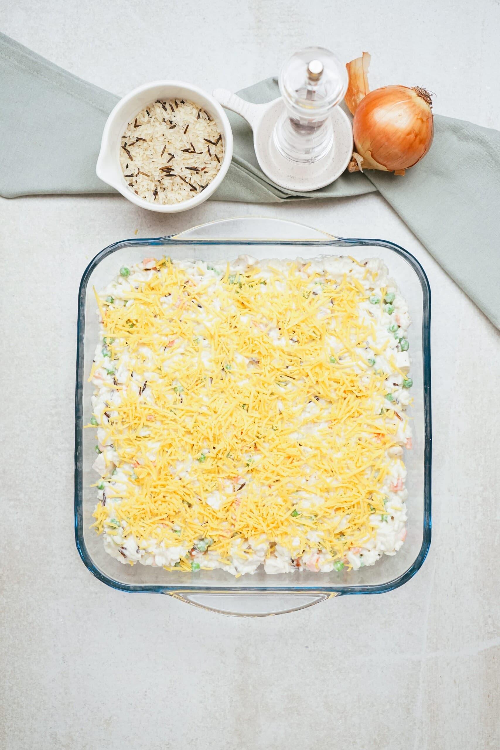 chicken wild rice casserole with shredded cheese on top