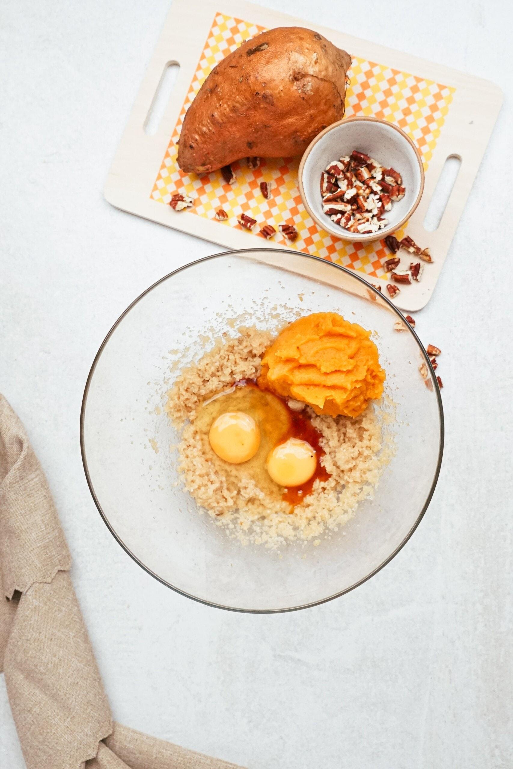 sugars, eggs and mashed sweet potato in a mixing bowl