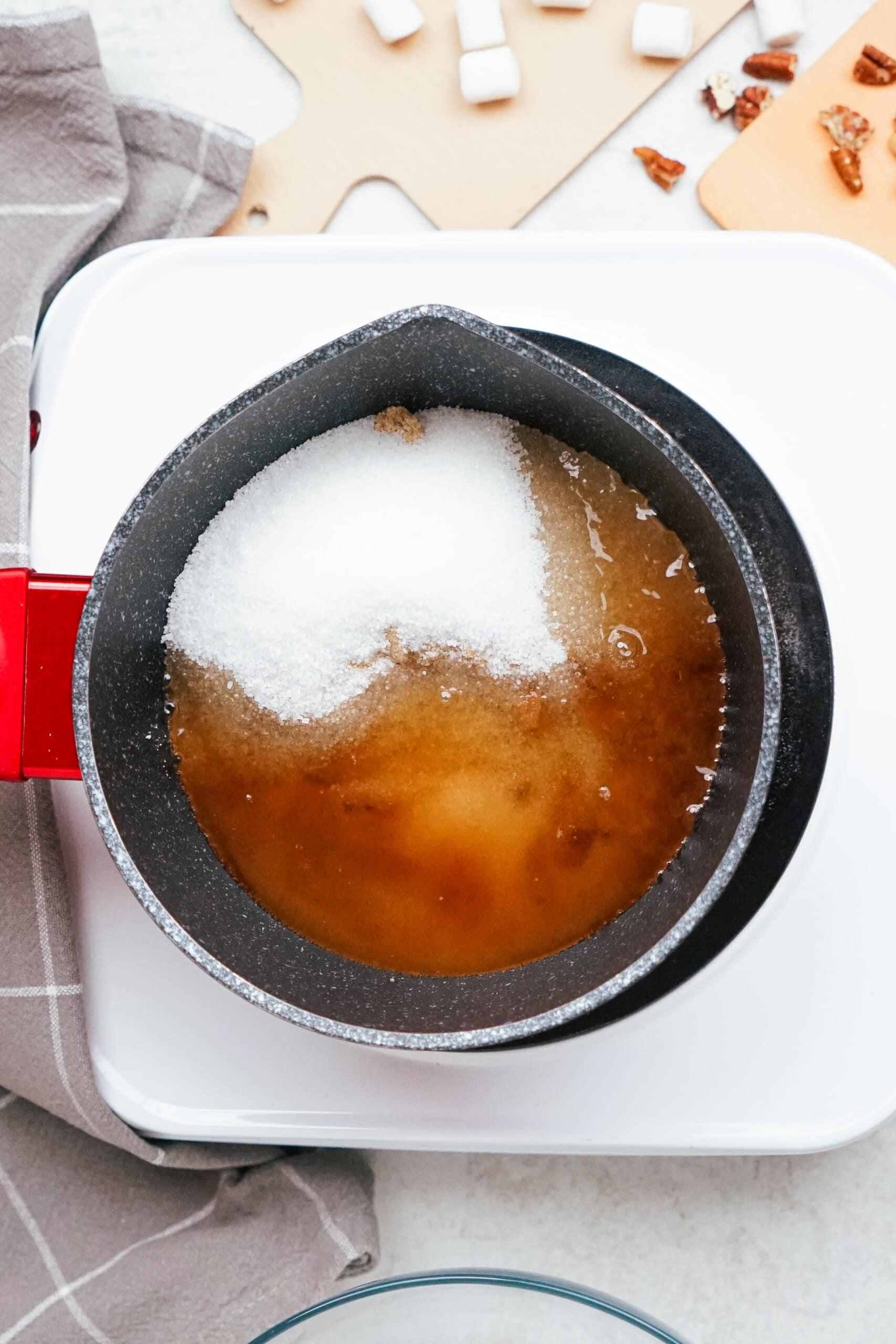 brown and granulated sugars in a pot with water