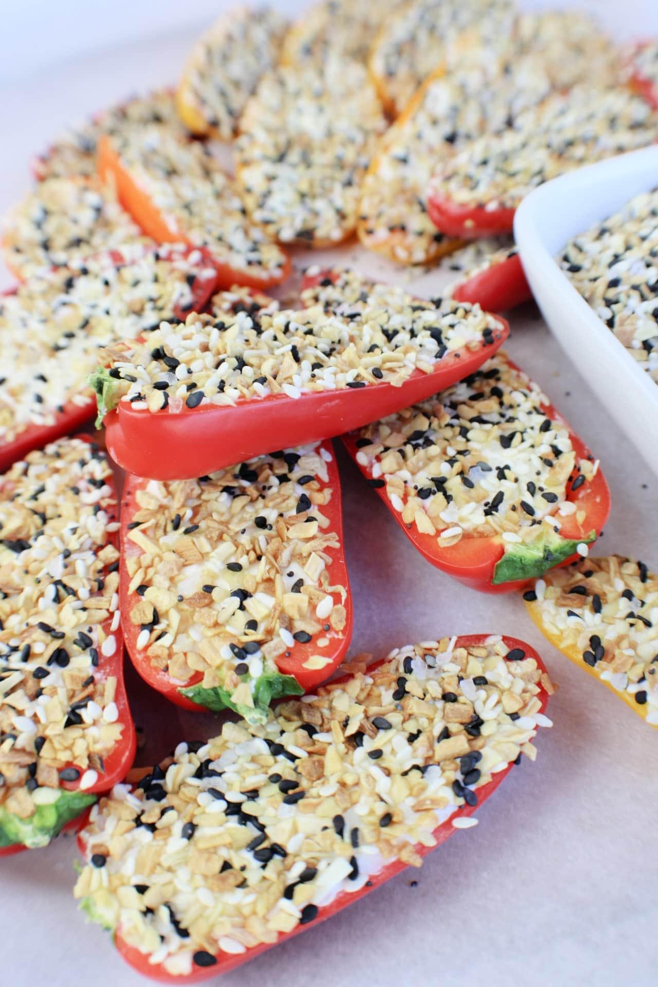 peppers filled with cream cheese and seasoning on a plate 