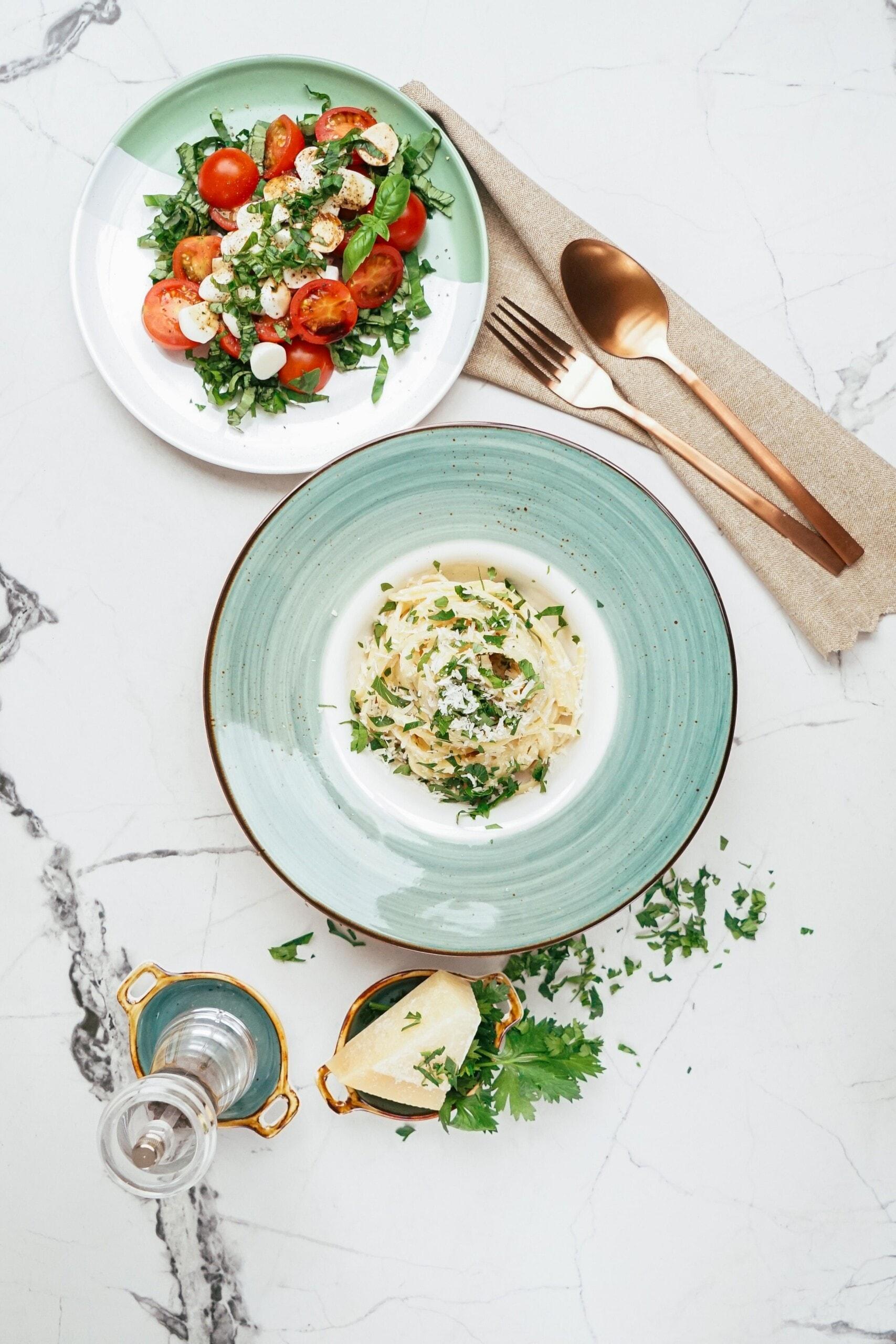 parmesan garlic linguine in a pasta bowl styled on a tablescape