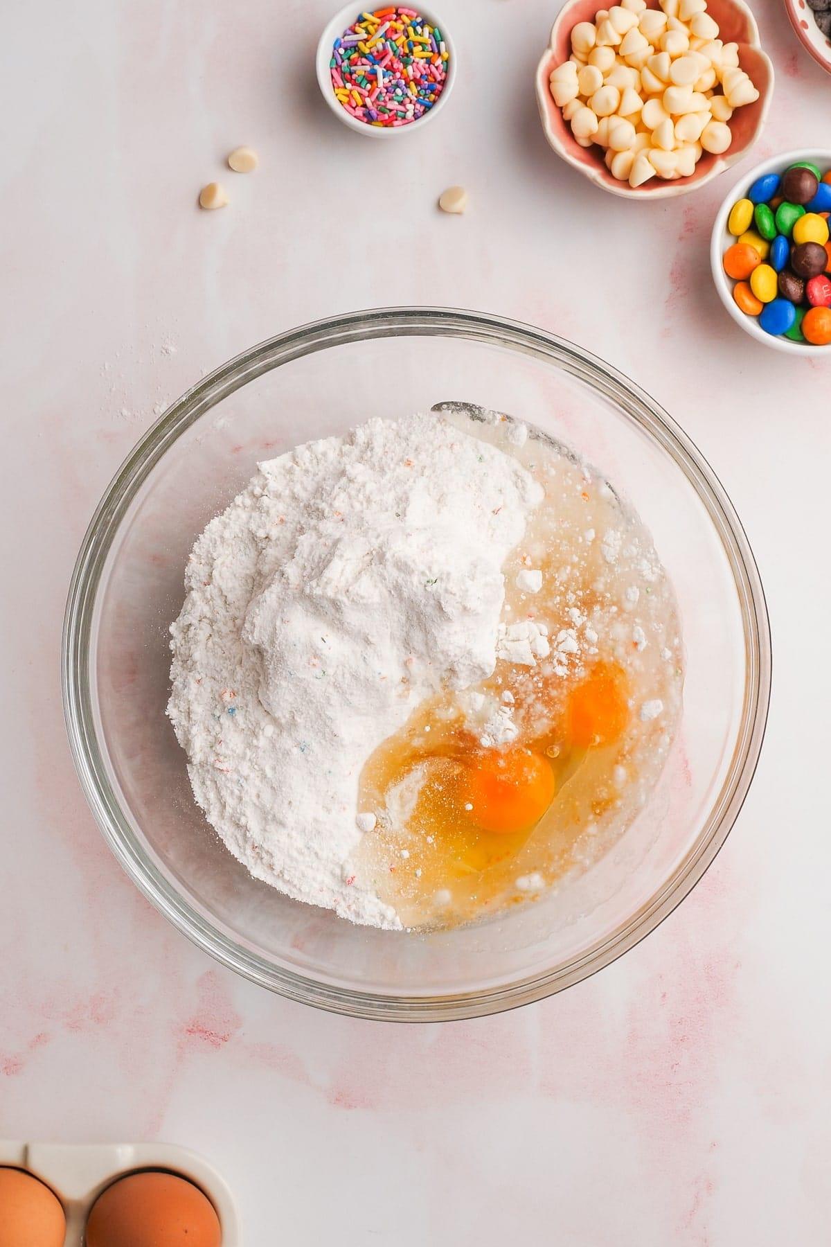 cake mix cookies ingredients in a glass mixing bowl