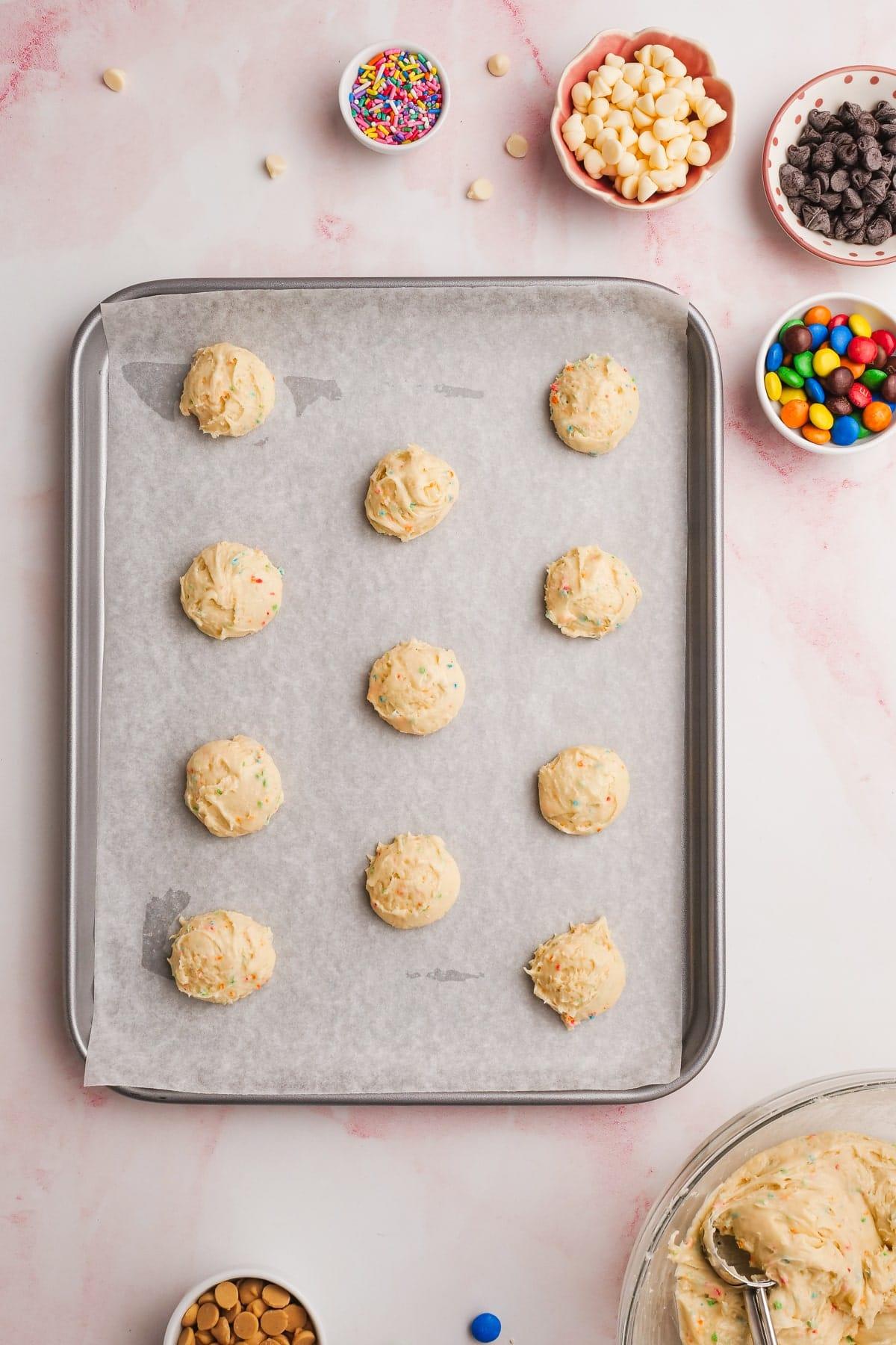 cake mix cookie dough in balls on a baking sheet