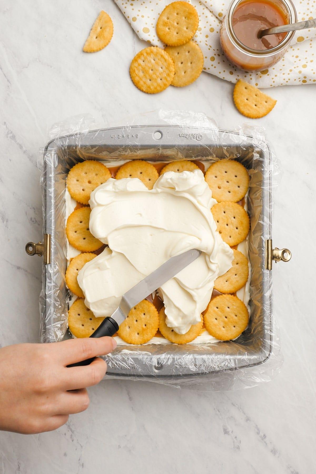 more cream cheese mixture spread across the ritz crackers, creating layers