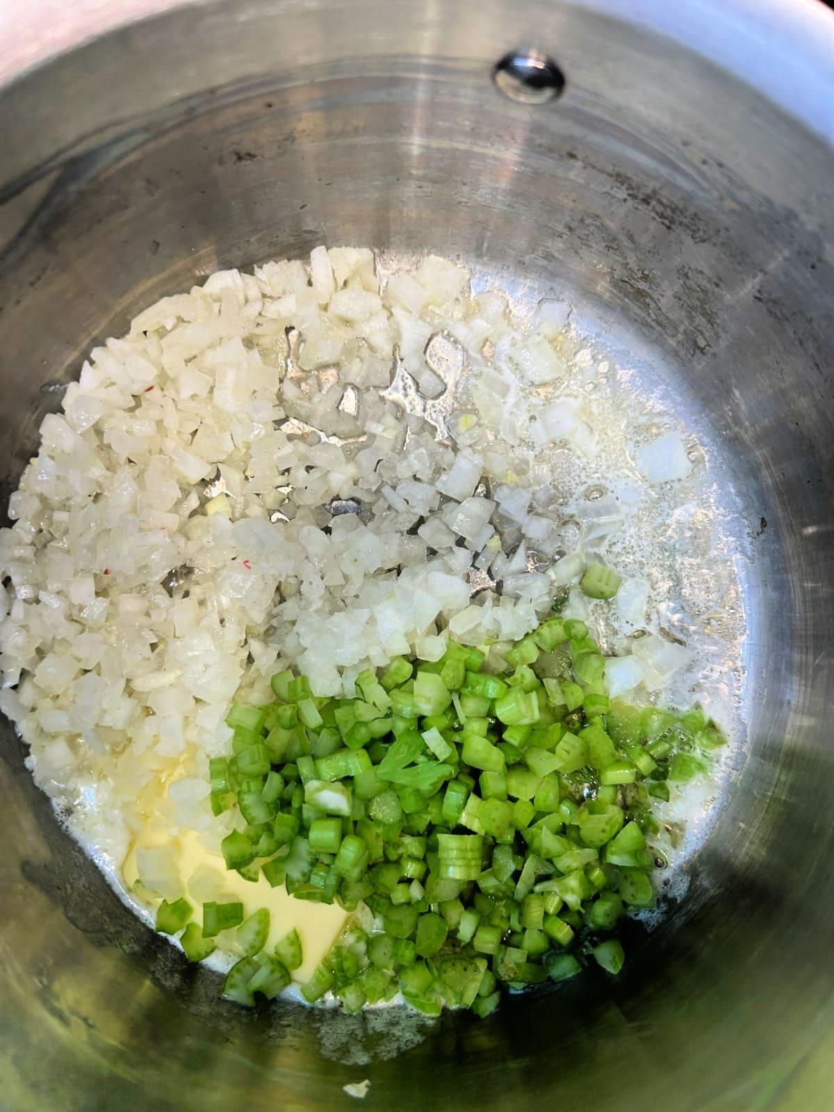 butter, onions and celery cooking in a saucepan