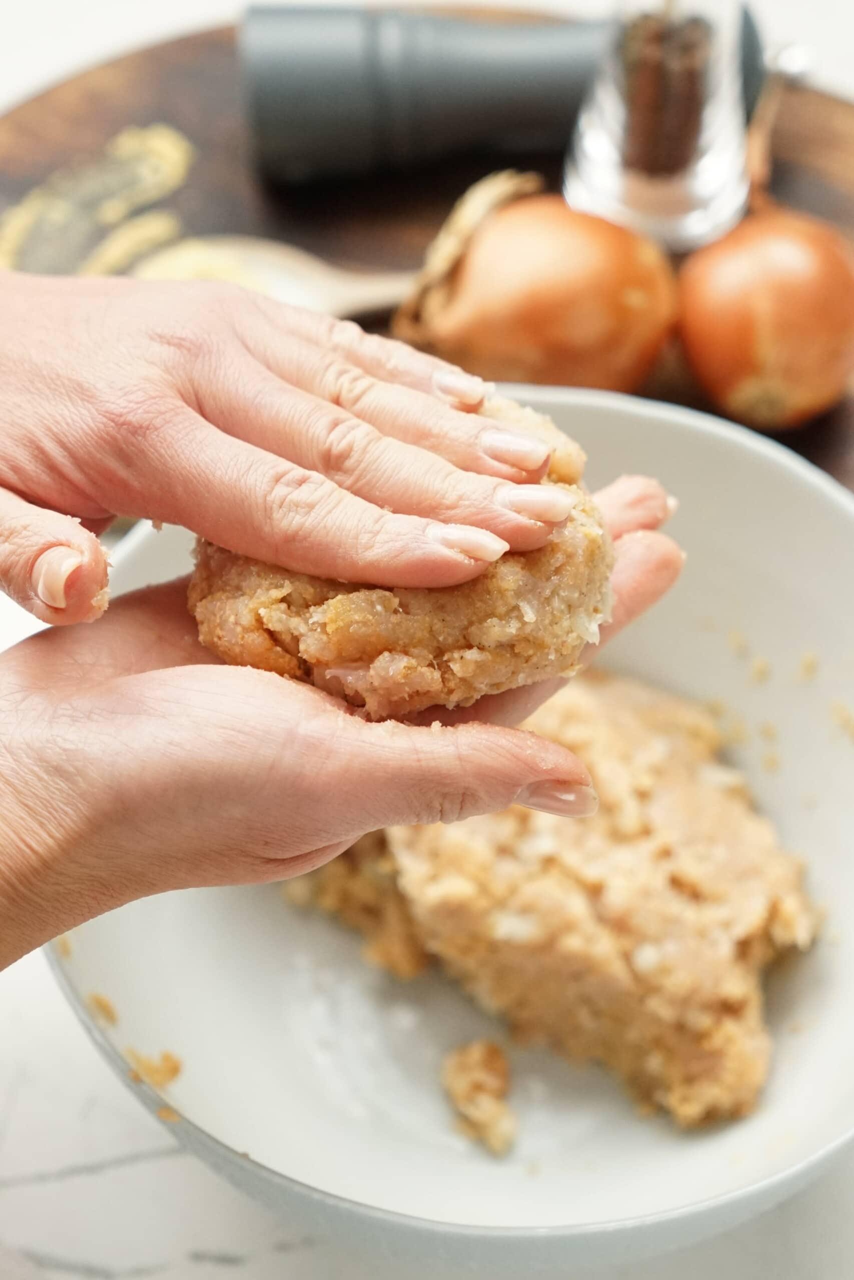 womans hands forming a meat patty