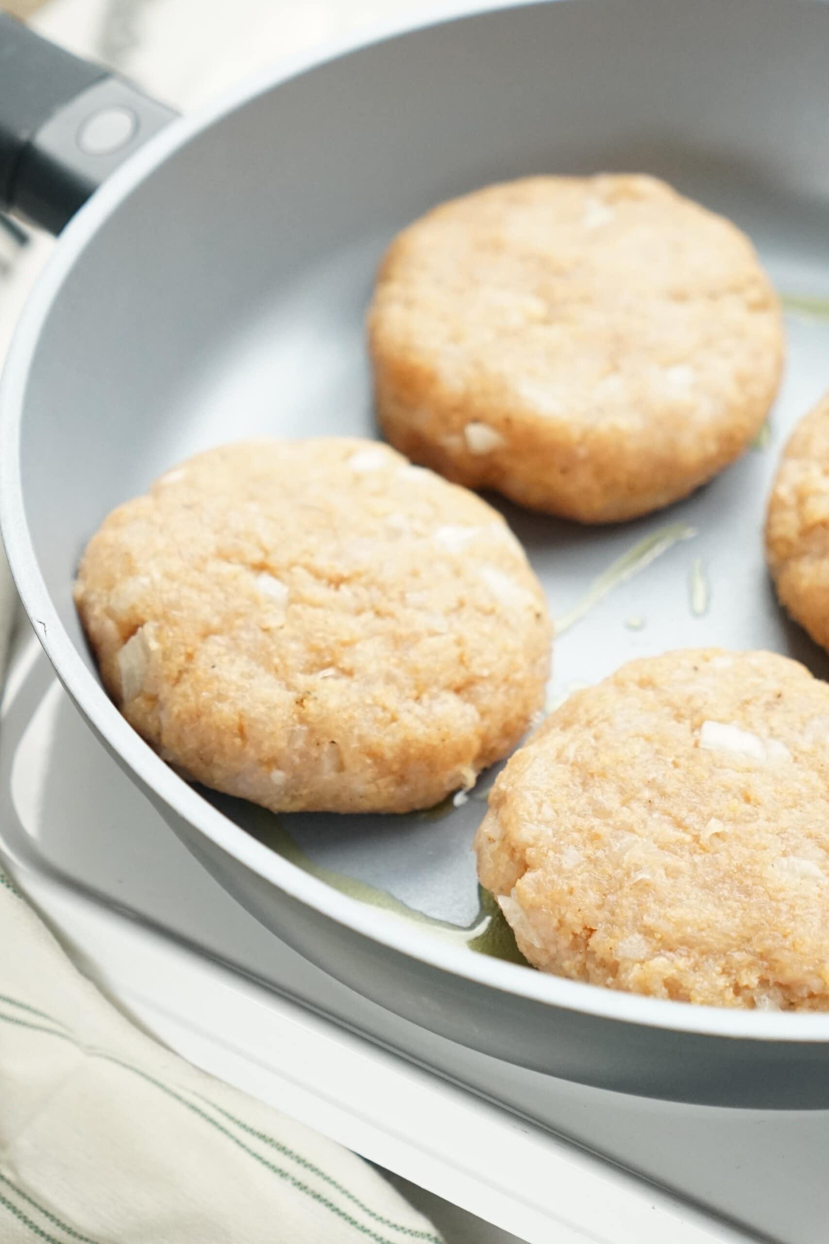 turkey patties cooking on a skillet