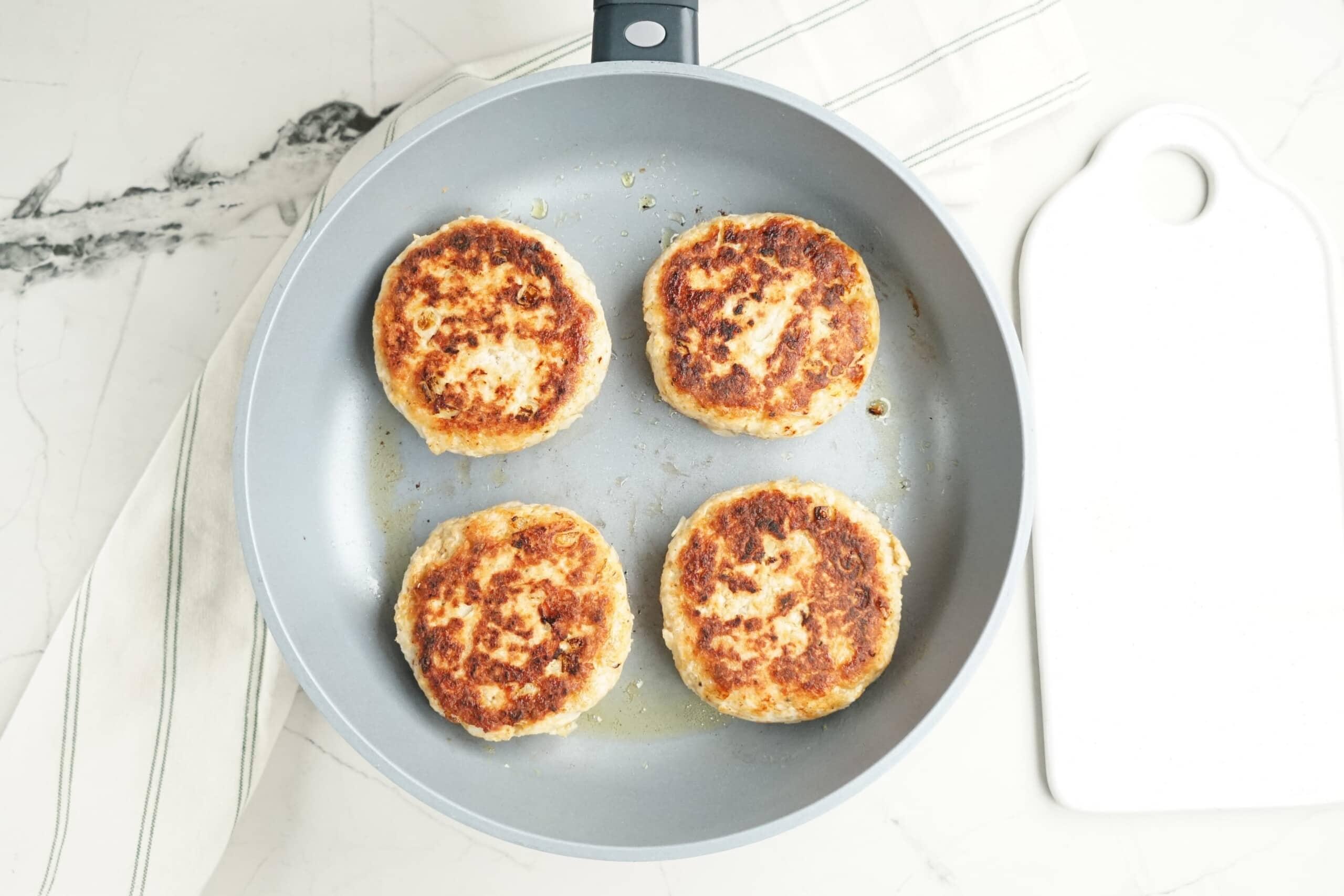 browned turkey salisbury steaks in a skillet