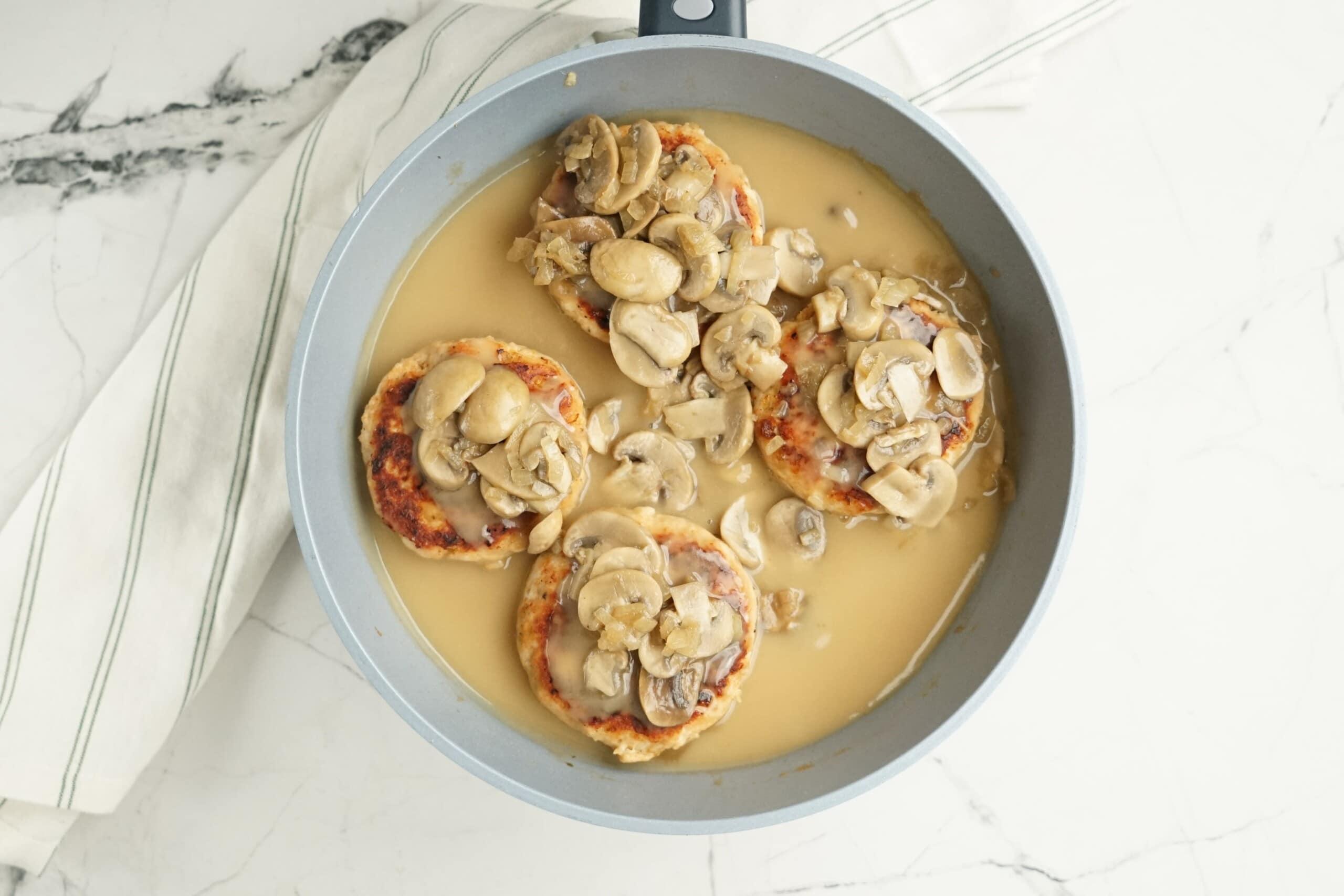 turkey salisbury steak with mushrooms and gravy in a skillet