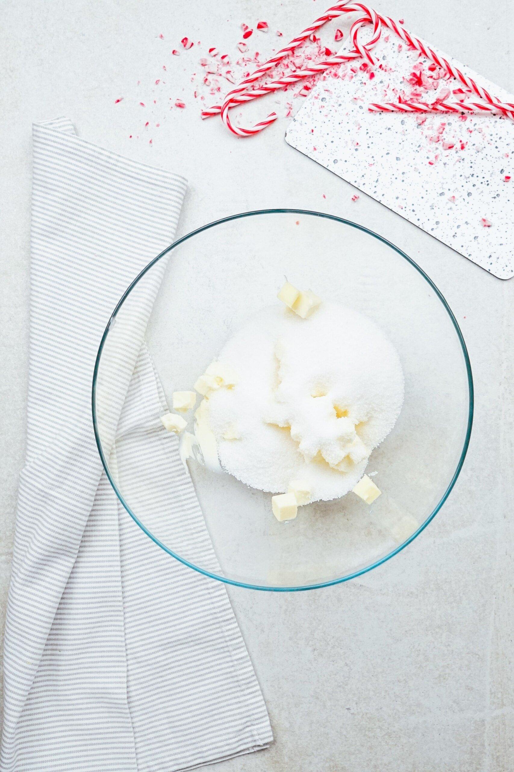 butter and sugar in a glass mixing bowl