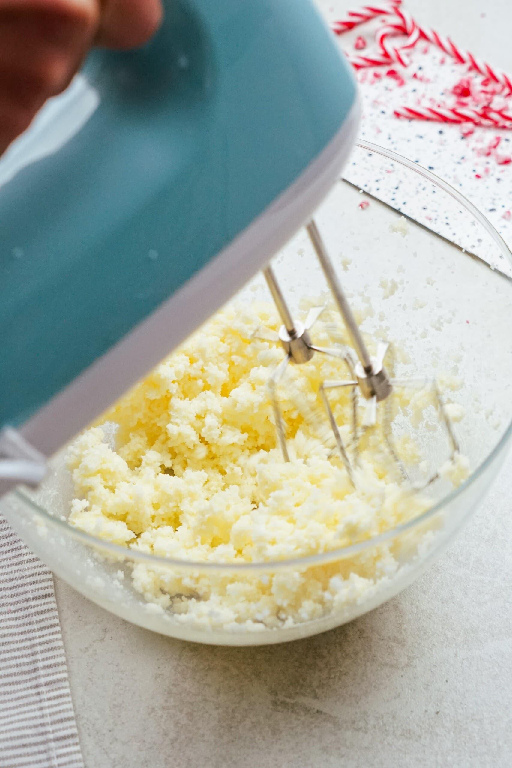 hand mixer combining butter and sugar