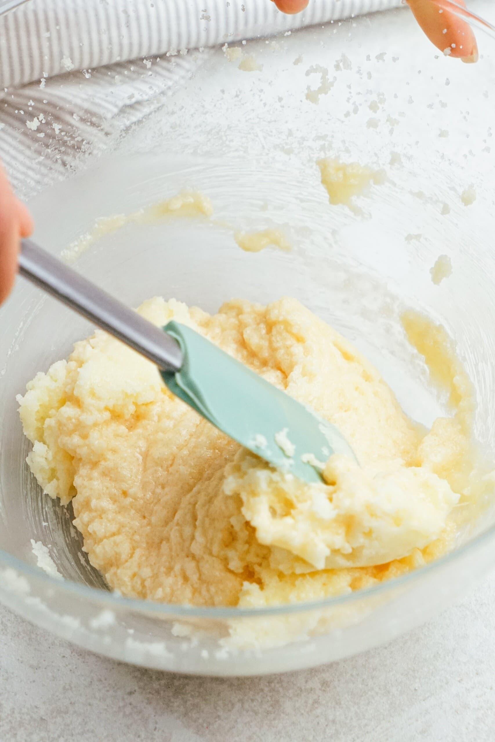 cookie dough in a bowl with rubber spatula 