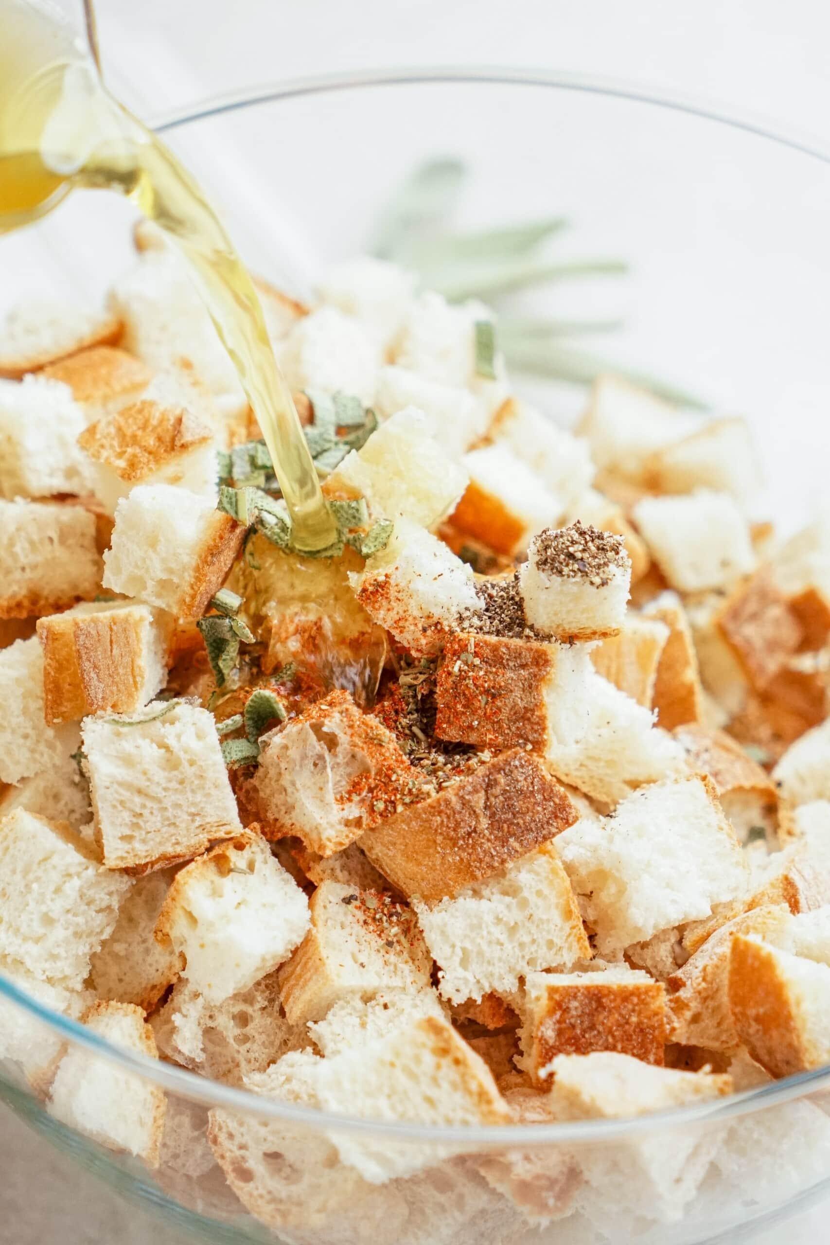 chicken broth being poured over bread cubes