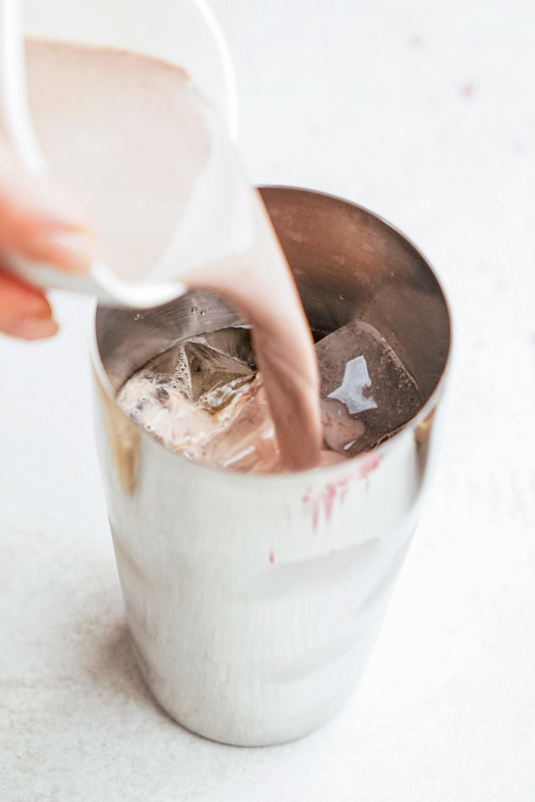 pouring into a cocktail shaker