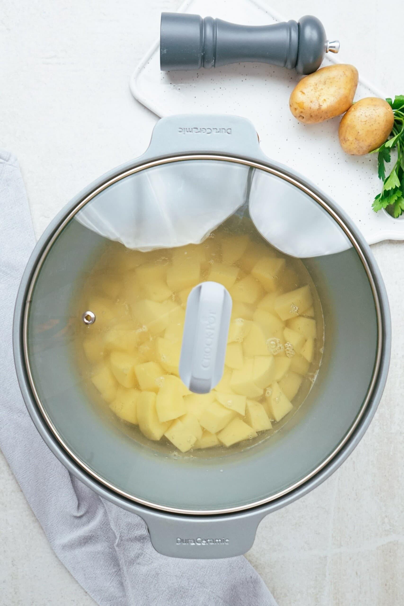 Potatoes cubed potatoes in a crockpot with clear lid
