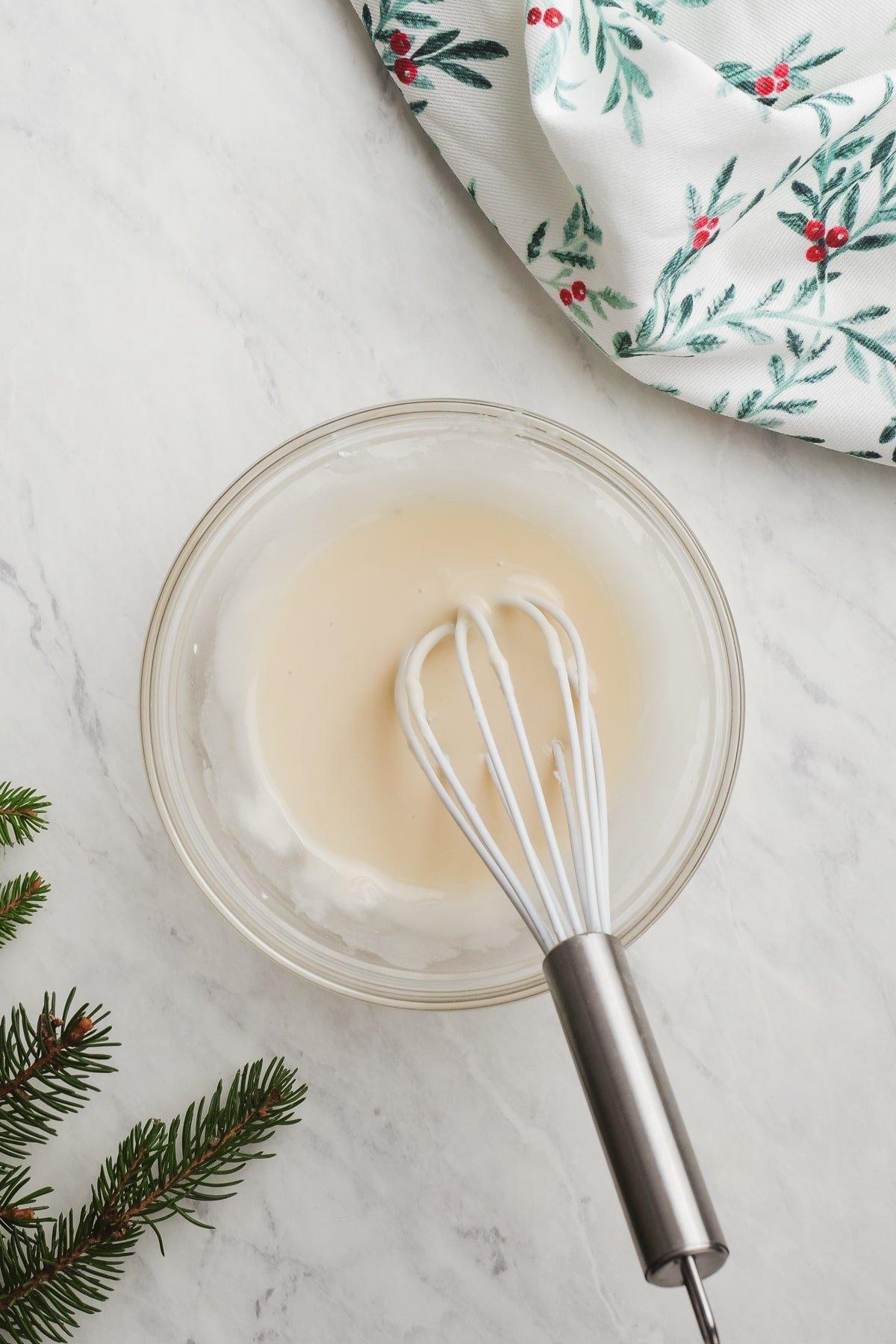 icing in a bowl with a whisk