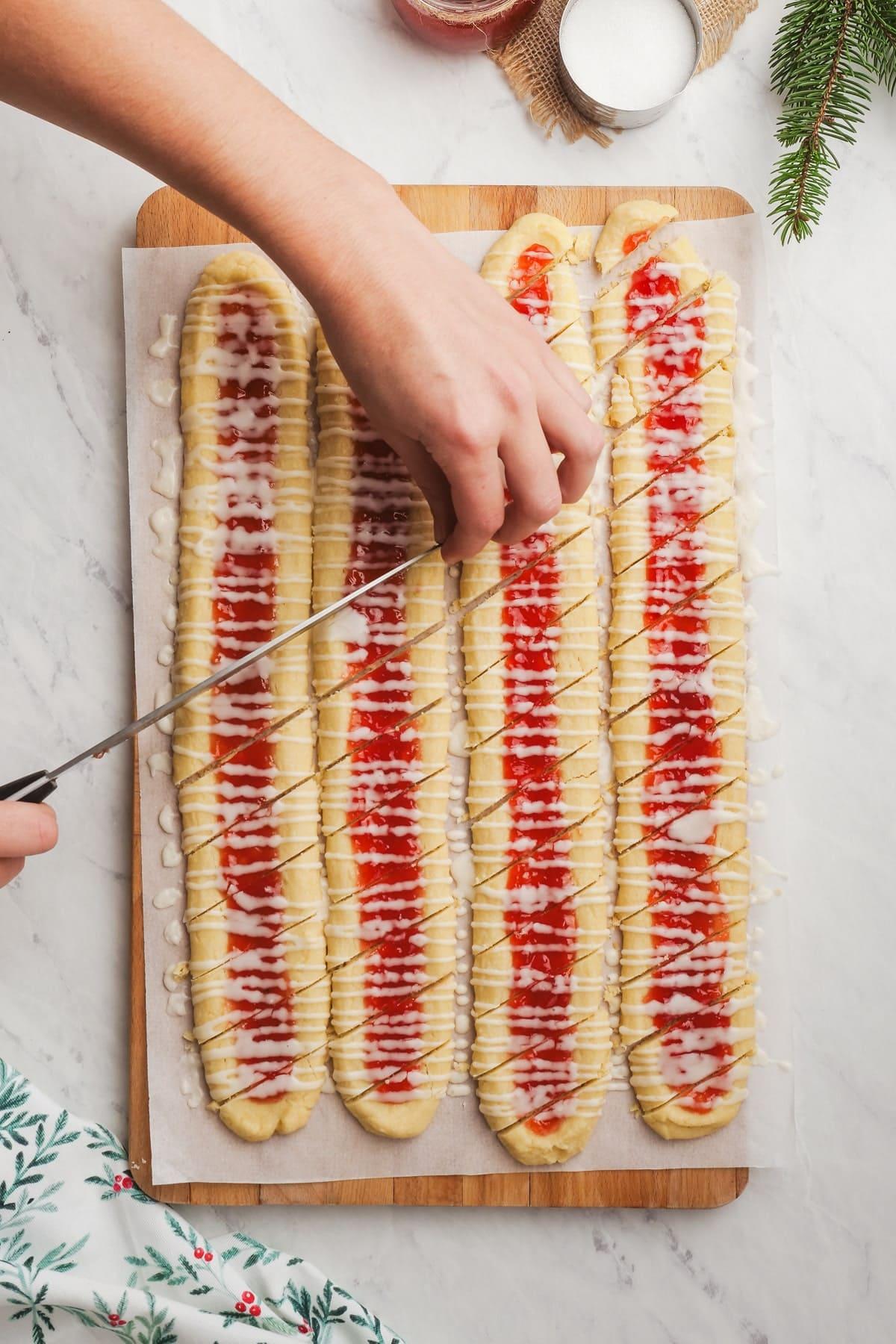 womans hands diagonally cutting shortbread cookies