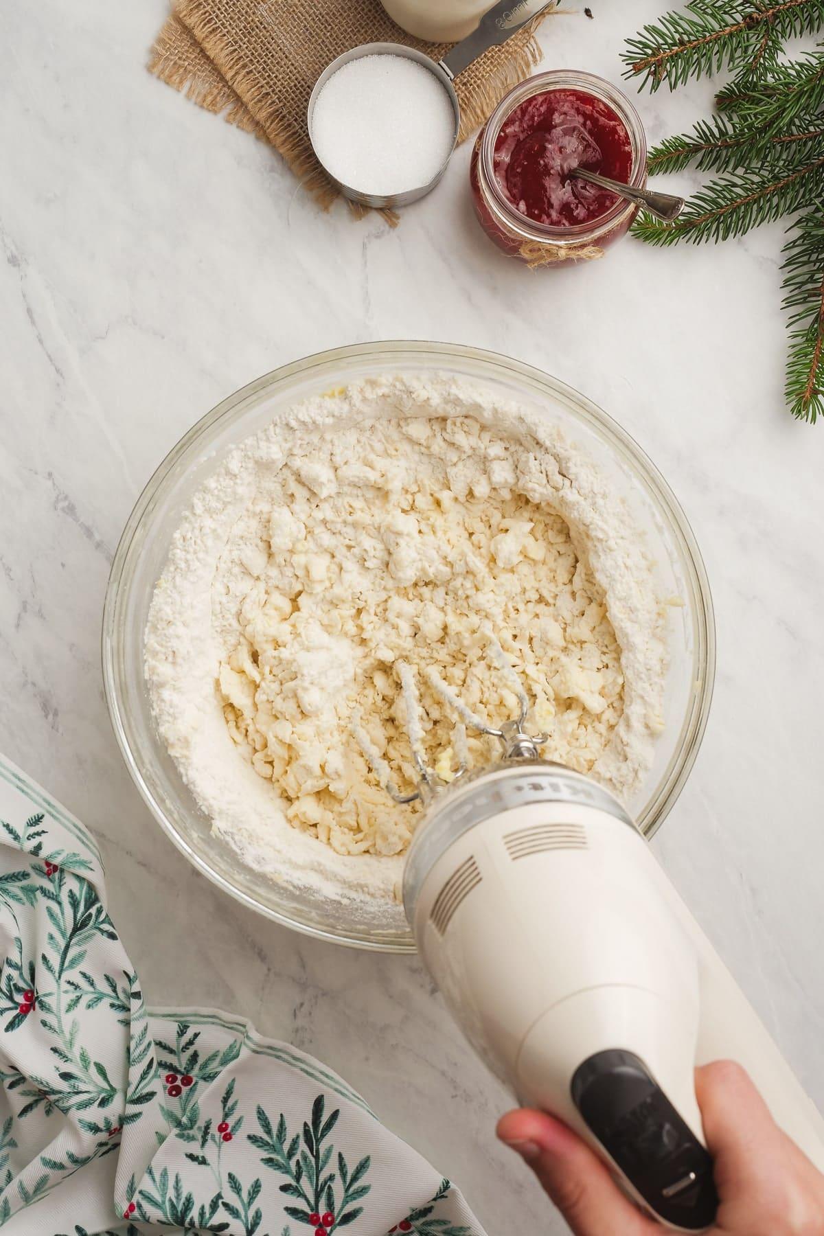 shortbread dough being mixed with a hand mixer