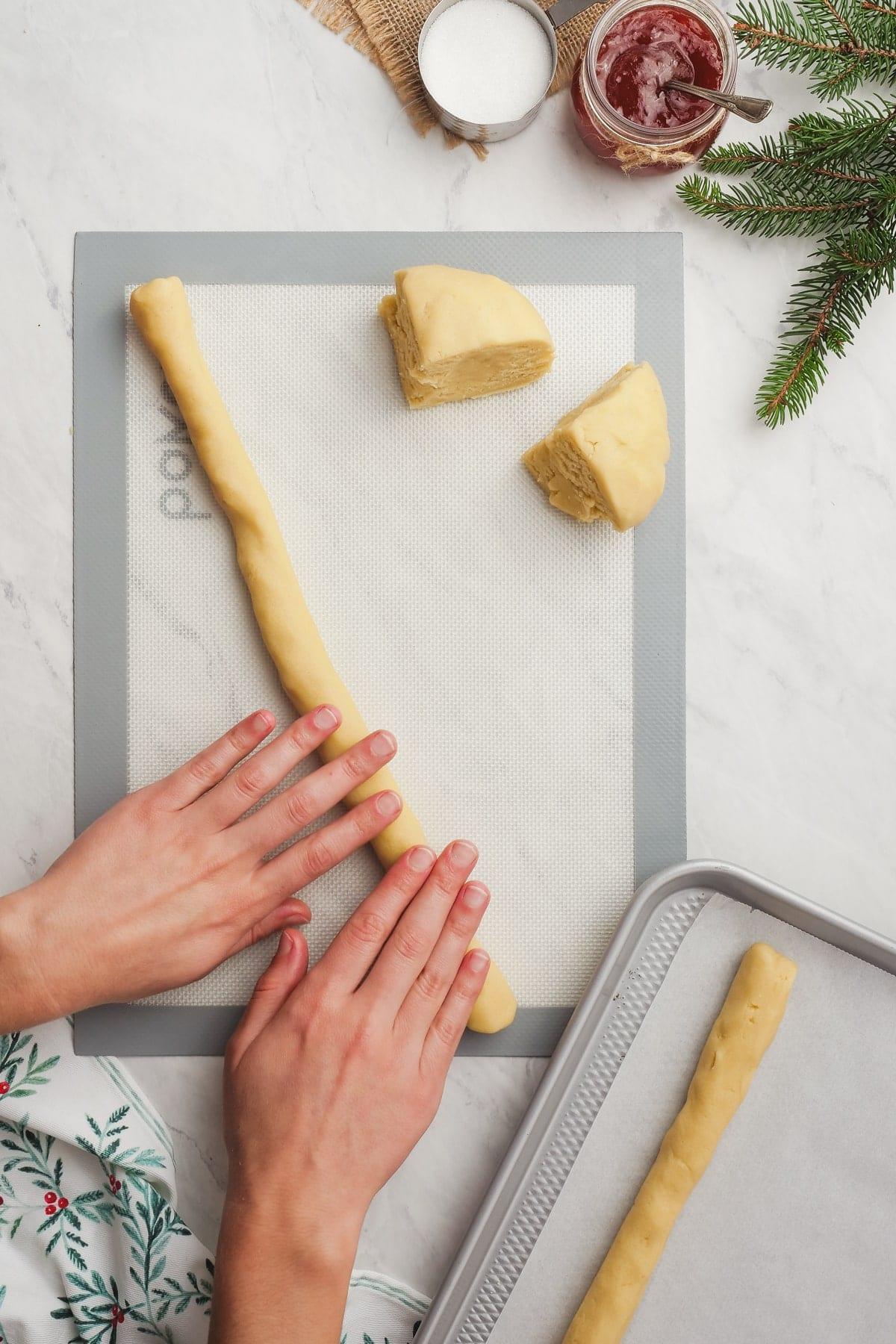 woman's hands rolling out cookie dough