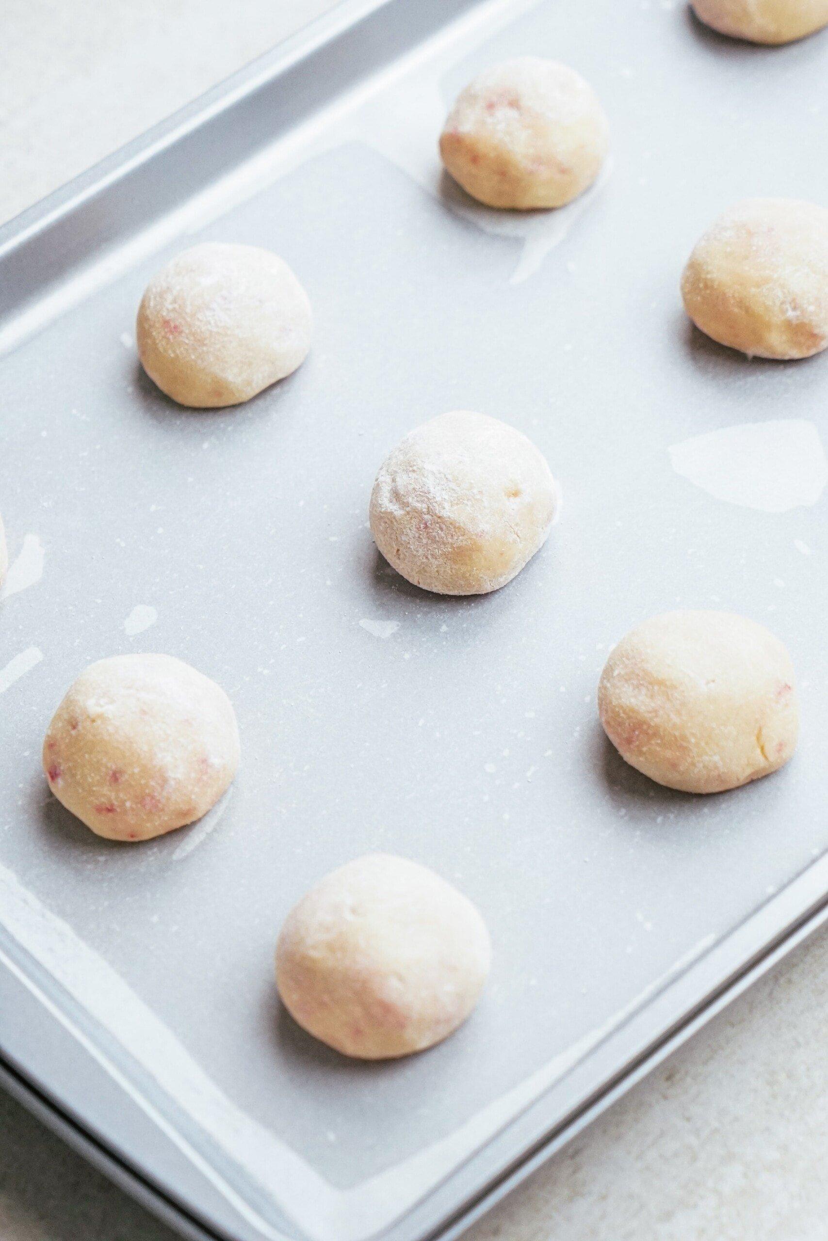 cookie dough balls on a baking sheet