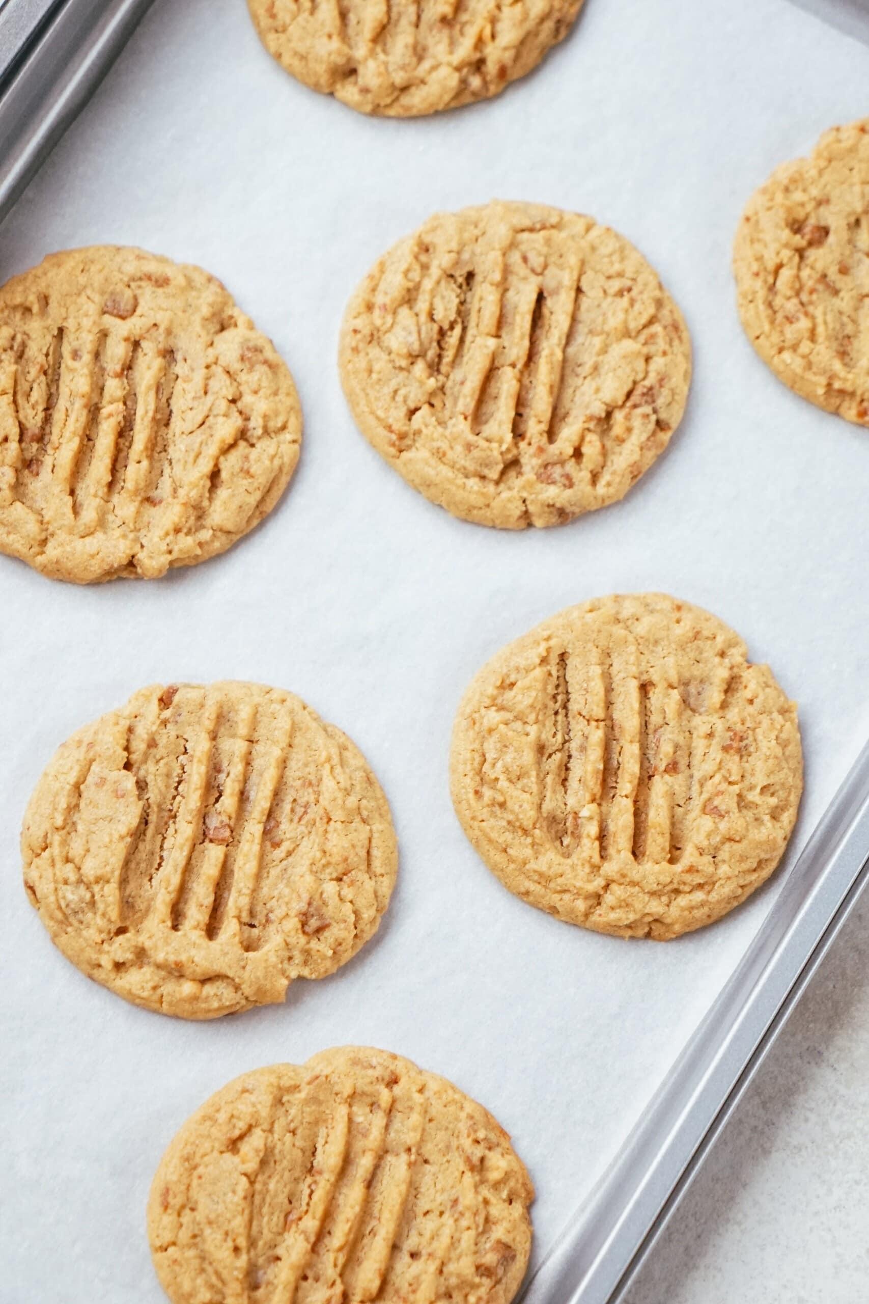 baked pb cookies on a cookie sheet