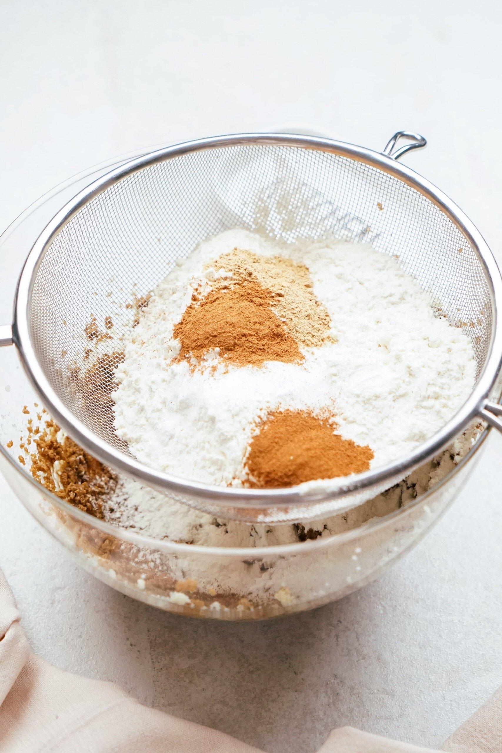 sifting in dry ingredients to the bowl