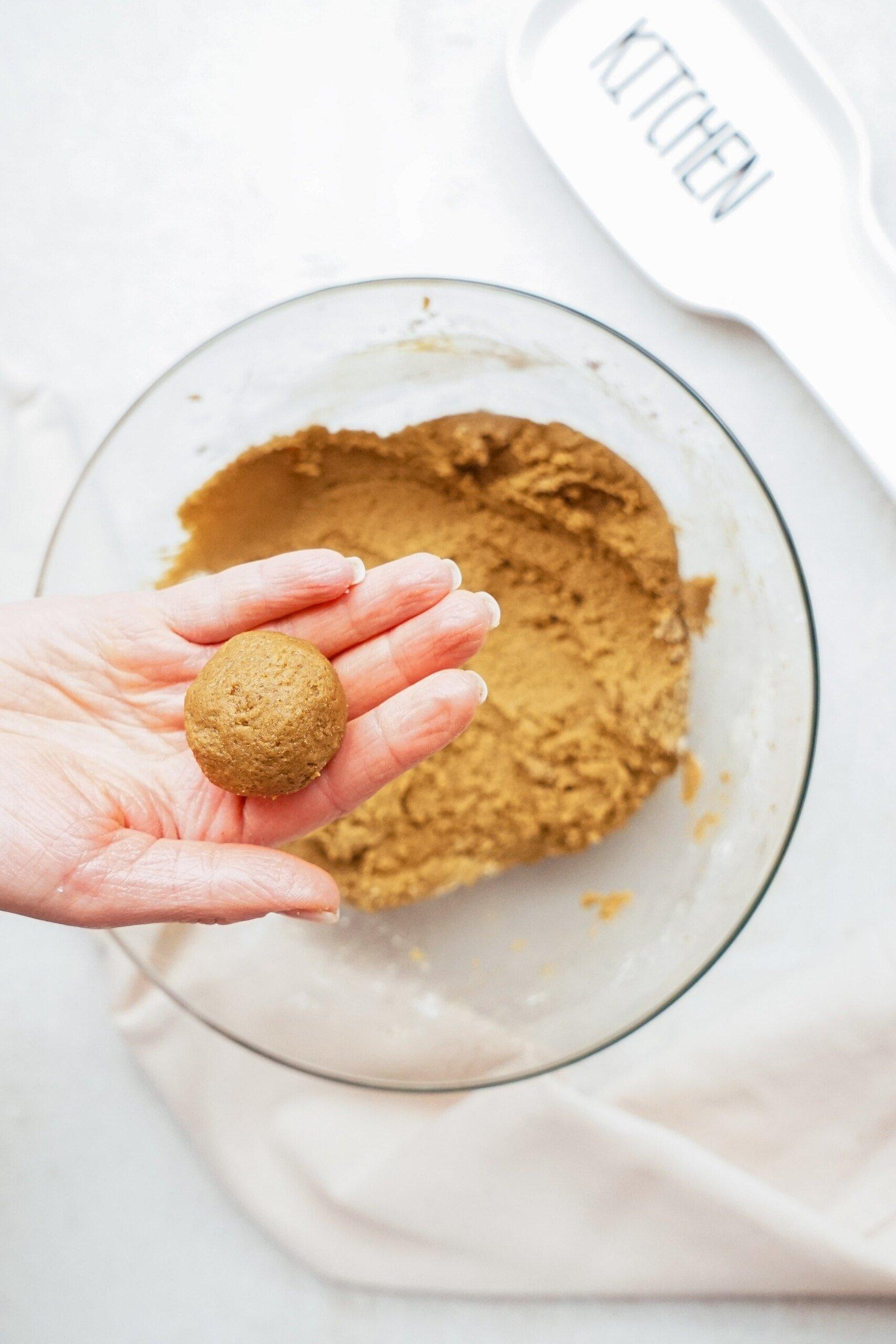 cookie dough ball in womans hand 