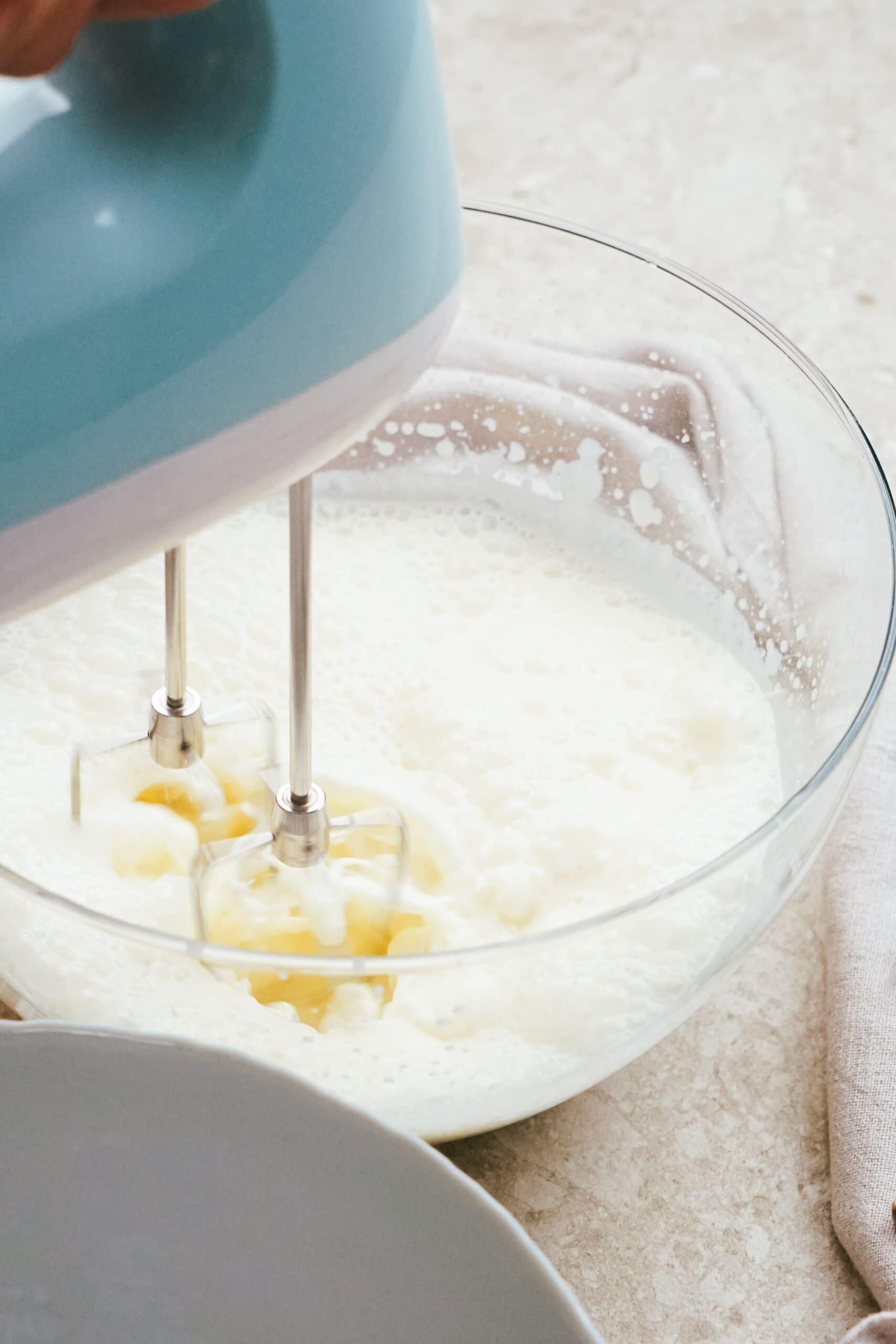 hand mixer mixing sugar and egg