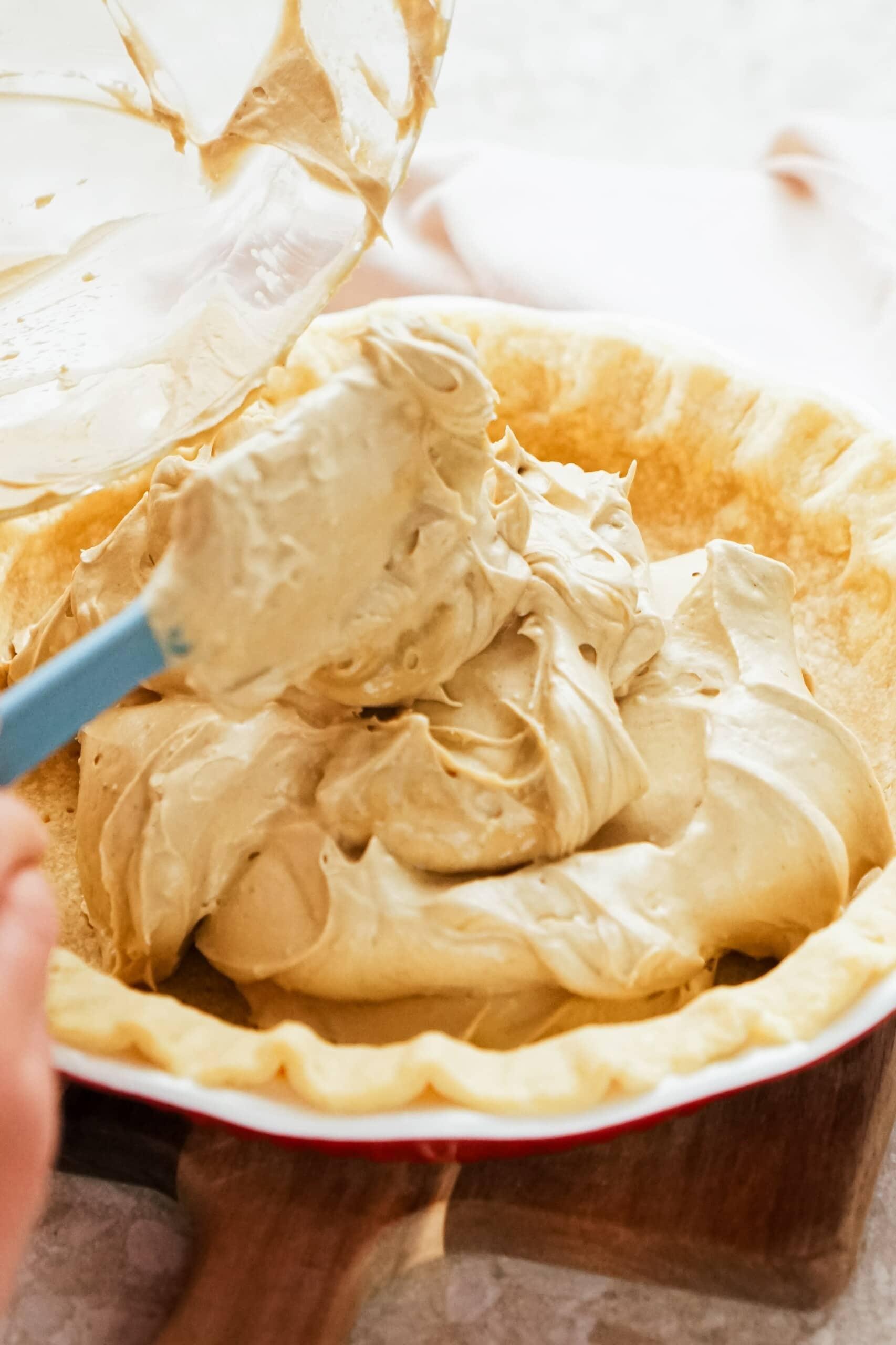 adding filling to pie crust