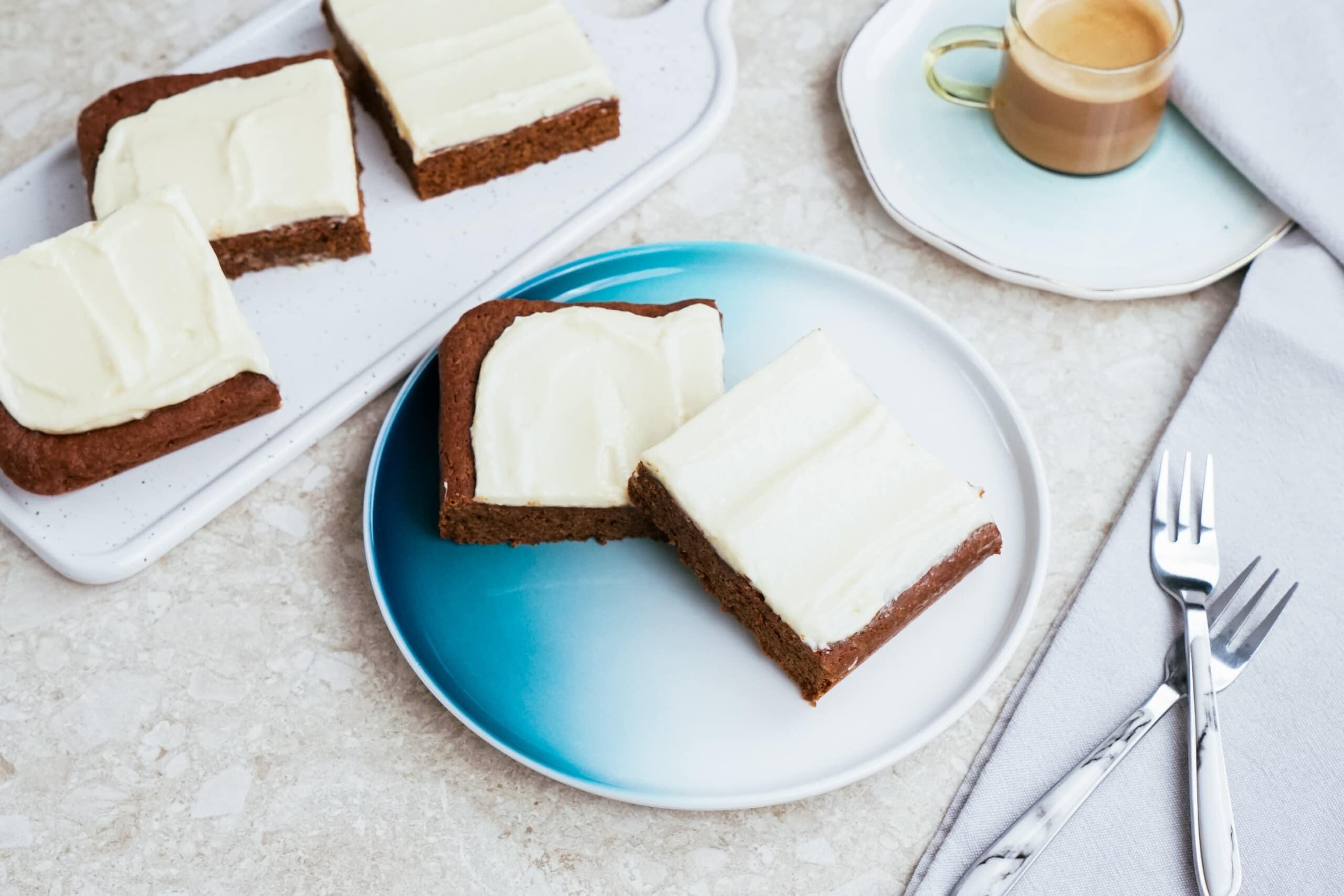 gingerbread bars with cream cheese frosting on a tablescape