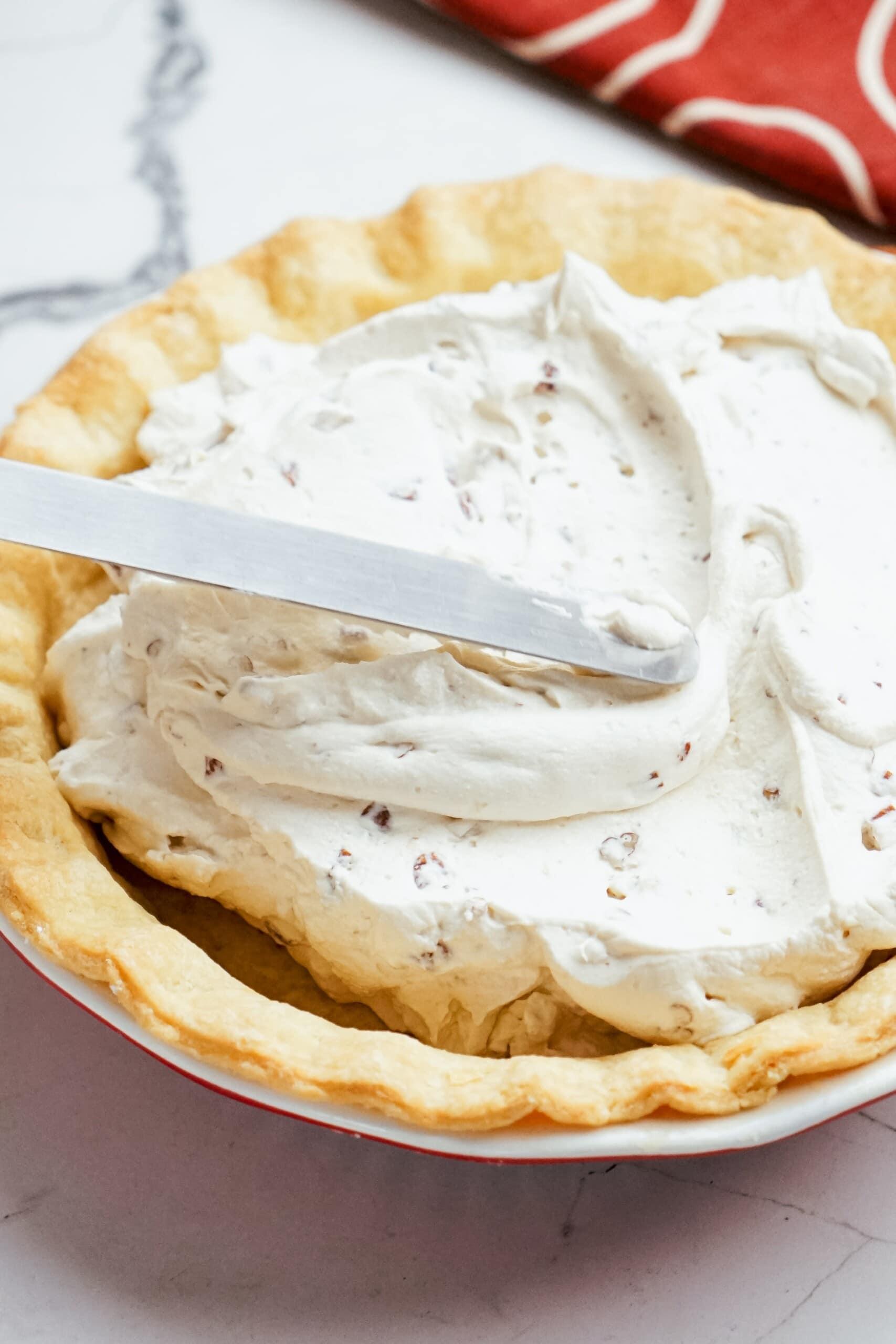 smoothing filling into pie crust 