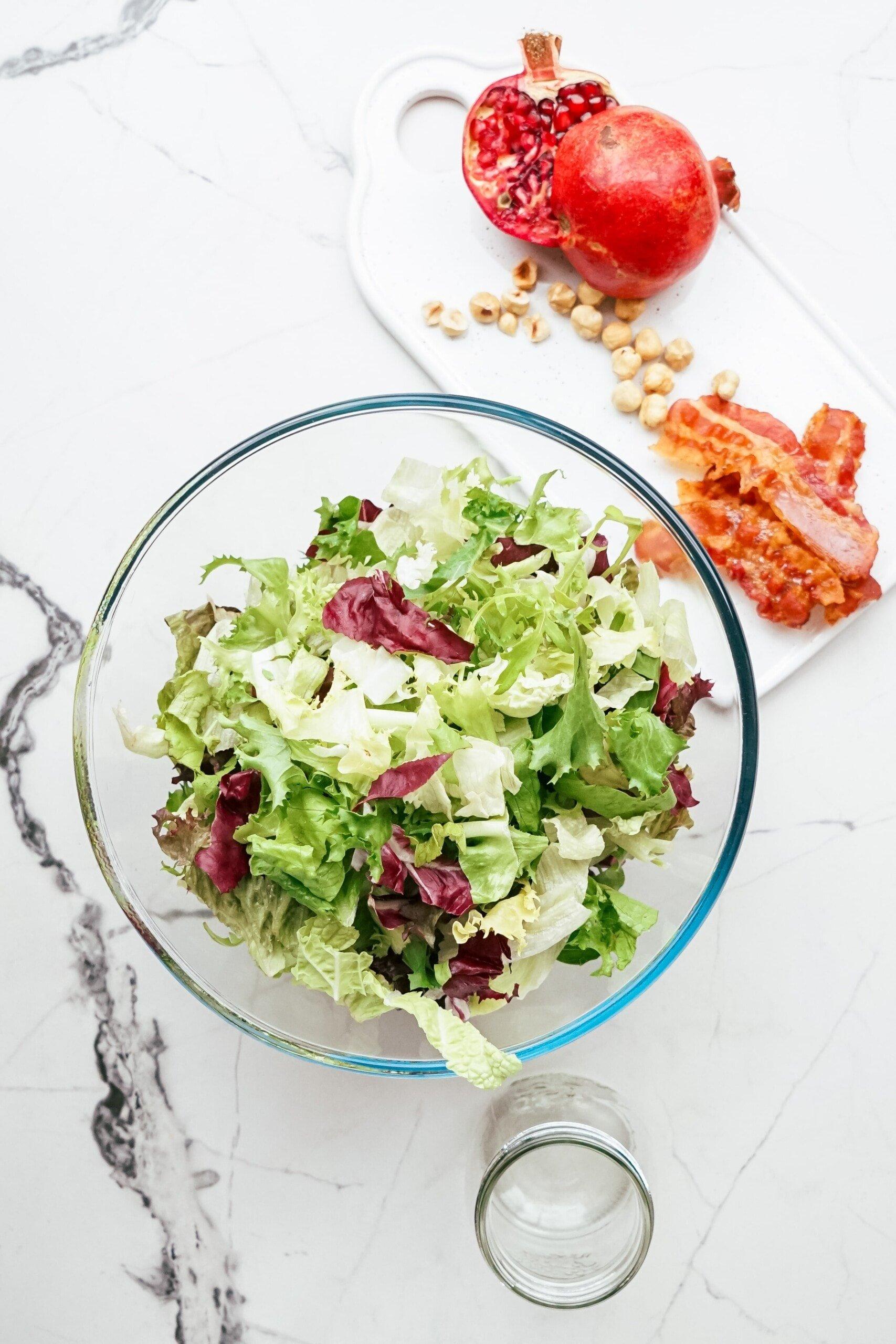 mixed greens in a glass mixing bowl 