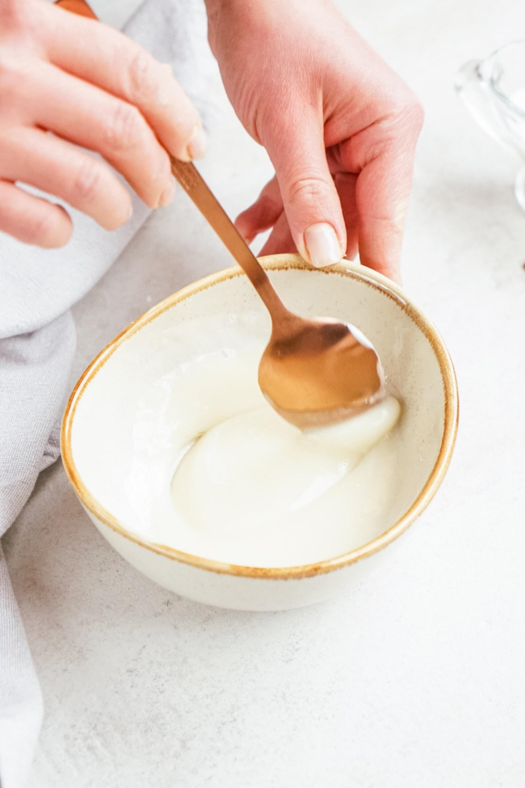 stirring yogurt and powdered sugar together