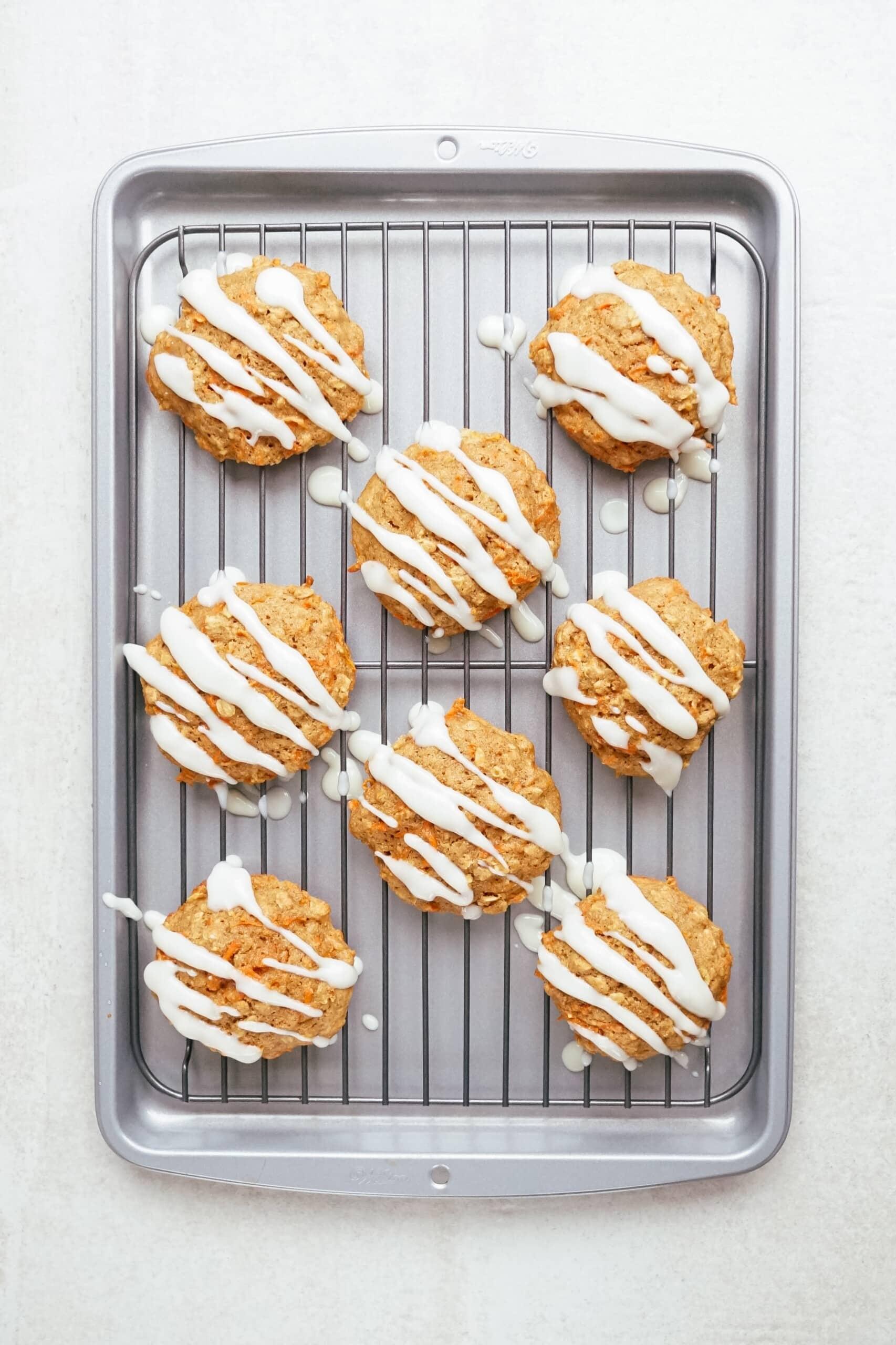 carrot oatmeal cookies on a cooling rack with glaze drizzled 